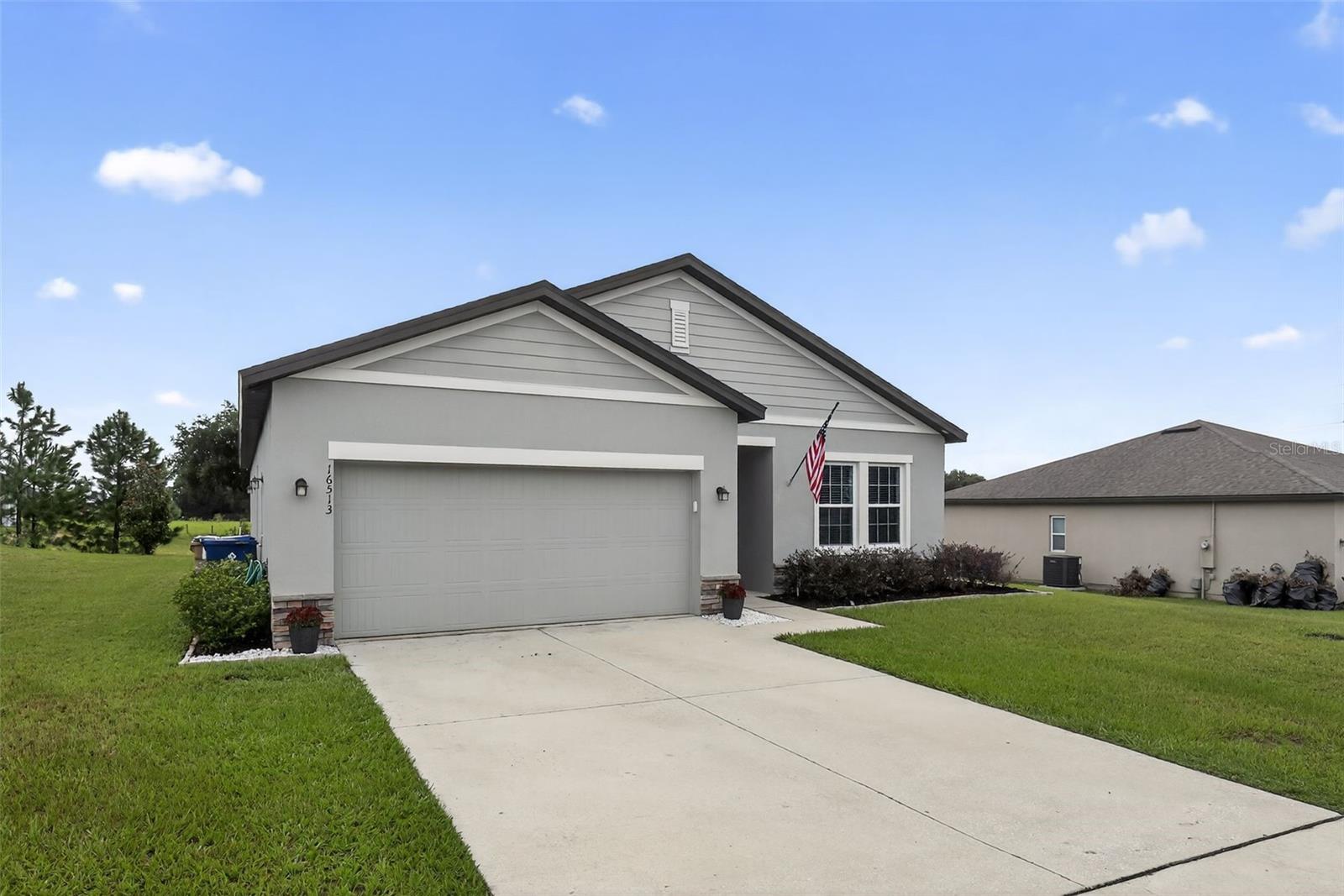 Under contract-accepting backup offers. Located just minutes from the Minneola Turnpike Exchange, this home combines quiet community living with easy access to major highways, shopping, and dining. It is a perfect home for a growing family and is eligible for USDA financing and seller-paid closing cost incentives, this home offers exceptional value and is move-in ready with many model home upgrades.
Inside you will find a beautifully upgraded Florida-style home featuring a 4-bedroom, 2-bath split floor plan with an open living concept, 10-foot ceilings, lighting fixtures, ceiling fans, LVP, 2" blinds, and double pane windows throughout with a vaulted main living area that creates an open, airy feel. The home also features an electric fireplace and is pre-wired for a security system with additional ethernet hookups, providing comfort and convenience for today’s work-from-home lifestyle. The upgraded kitchen boasts granite countertops, a sleek upgraded faucet, stainless steel appliances including an upgraded refrigerator, and enhanced lighting fixtures for a warm, inviting space.
Step outside to enjoy a picturesque backyard view overlooking a small farm and nursery, offering a peaceful retreat from daily life. The exterior upgrades include an extended rear patio perfect for entertaining, a gazebo, a full irrigation system, an upgraded front door with Ring doorbell, and a convenient side door on the garage.
This isn’t just a house; it’s the perfect backdrop for your family’s story. Don’t wait — come see why 16513 Cherry Landing Dr. is where your future begins.