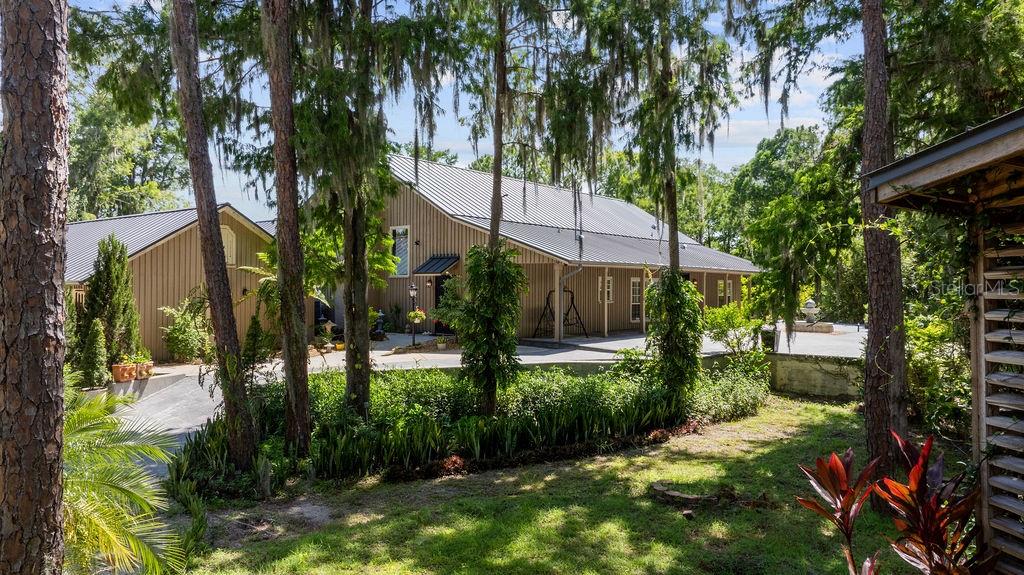 Discover the perfect harmony of indoor elegance and outdoor tranquility in this stunning lakefront estate situated on **over 4 acres** along **500 feet of Lake Mary Jane frontage**.
Inside, enjoy over **3,500 sq ft** of beautifully updated living space featuring **4 spacious bedrooms** and **3 luxurious bathrooms** with marble finishes, soaking tubs, and heated towel racks. The living room impresses with a **quartz fireplace**, vaulted ceilings, and custom chandeliers that create a warm, luxury atmosphere. The renovated kitchen boasts modern, upscale finishes designed for both everyday living and entertaining. Step outside to an expansive **4,000 sq ft of fully screened outdoor living** space, complete with a **resort-style screened pool and spa**, and a **custom outdoor kitchen** outfitted with commercial-grade stainless steel appliances under a stunning **cypress wood ceiling**—perfect for seamless indoor-outdoor entertaining. The grounds feature a lush landscape filled with **orchids**, **tropical fruit trees**, and a whimsical treehouse, offering a private retreat immersed in nature. Plus, enjoy direct lake access with a **boathouse equipped with boat lifts**, making waterfront living and boating effortless.
Located just **18 miles from Orlando International Airport** and **25 miles from Orlando’s world-famous attractions**, this estate offers the best of both serenity and accessibility.
This exceptional home combines elegant indoor comforts with a spectacular outdoor oasis, all within a tranquil natural setting yet just minutes from major amenities, trails, parks, and the vibrant community of **Laureate Park at Lake Nona**.