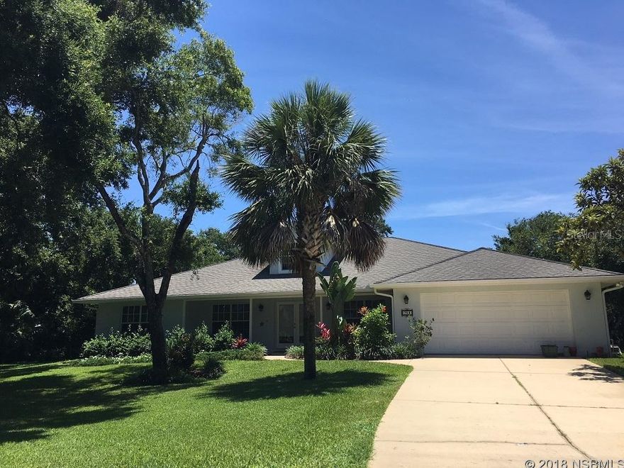 Florida coastal living is easy in this custom-built, single-story Key West style 5/3 home on a quiet cul-de-sac, steps to a non-driving beach, A-rated elementary school & shopping!  1st time offered by original owners, this executive home has nearly 2500 sq ft under air & 3800 total. Constructed in 2003 to the Florida building code on over a quarter acre lot with underground utilities, it backs to a wooded conservation zone for privacy. Enjoy listening to the waves while floating in your screened, heated, salt-water pool or relaxing on the lanai in this beautiful, park-like setting. The home has a covered front porch, French doors & soaring cathedral ceilings in the entry & great room, real hardwood floors in main living areas, formal dining room & master suite. View the pool and yard from French doors in the great room & oversized windows in the tiled kitchen & breakfast nook. The kitchen includes a built-in office, center island with prep sink, large pantry, 42â maple cabinets, & stainless steel appliances w/ 2018 Samsung convection range & microwave oven. The split bedroom plan w/ 2 separate master suites & private guest wing leads to 2 bedrooms &  full bath, office/den can be 5th bedroom. Indoor laundry room w/ Whirlpool washer and dryer, ample shelving, storage closet, & utility sink. The oversized 2-car garage w/ new hot water heater (2017), garage door opener, utility sink, storage shelves, attic access, attic fan. Upgrades: updated lighting fixtures, 6â base trim, rounded corners, kitchen-height vanities, ceiling fans in bedrooms, den, great room & lanai, well-maintained 6-zone sprinkler system with deep well & pump. Recent updates: new pool filter & heater (2013), salt chlorination system & pool pump(2017), new landscaping & sod (2016). The heated outdoor shower is great after a dip in the pool or day in the surf.  This home is located only a short bike ride to Flagler Avenue or Bethune Beach! ;Water: City