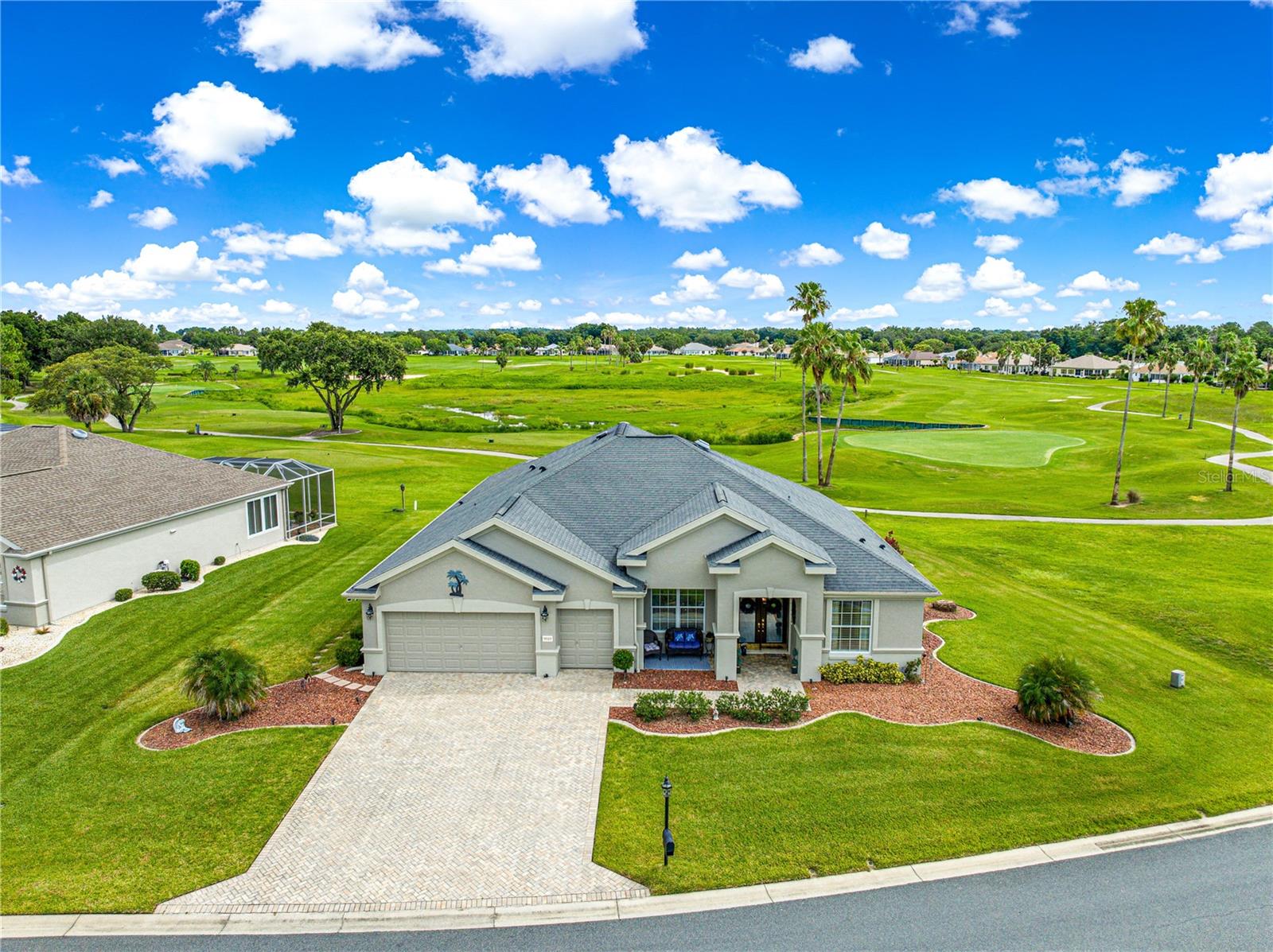 Welcome to this exquisite Home in Guard Gated Del Webb Spruce Creek Golf & Country Club. This home is situated on the third hole of the Masters Golf Course, offering sweeping views of holes one and two. With 3,222 square feet of heated and cooled living space, this home provides the ultimate blend of luxury and comfort—and there are no bonds or CDD fees. This LEXINGTON (the largest model floor plan built in Del Webb) 3/2 plus an office/den model with 3 car garage, has plenty of room for a pool! Step through the grand double-door entry to be greeted by breathtaking golf course views. Enjoy morning coffee or evening sunsets from this oversized enclosed lanai overlooking the manicured greens. The large kitchen with Island, has canned lighting and desk area overlooking the large family room. This one is a split floor plan which is perfect for guests. A large primary bedroom suite that has sliding glass doors to the enclosed lanai. Ensuite bath has a large walk-in closet, shower, double sinks and a garden tub. With a large double garage, plus a golf cart garage there is plenty of space for hobbies. Three Mini Splits recently installed. The lot next door is empty giving you plenty of space to enjoy the outdoors. There are so many upgrades and features to this beautiful home. The Community is packed with activities, (Club house, golf, fitness center, softball field, basketball court, horseshoes, shuffleboard, bocce, walking trail, pavilion on the lake, 3 pools, 2 hot tubs, billiards, pickleball courts, ballroom, hobby rooms, social activities daily). Liberty Grill Restaurant next to Horizen Center Clubhouse. Home Painted inside and out 2023, New Attic Insulation installed 2024, Kitchen Back Splash 2023, Roof 2015, HVAC 2016, Hot Water Heater 2025. Owner is the Agent