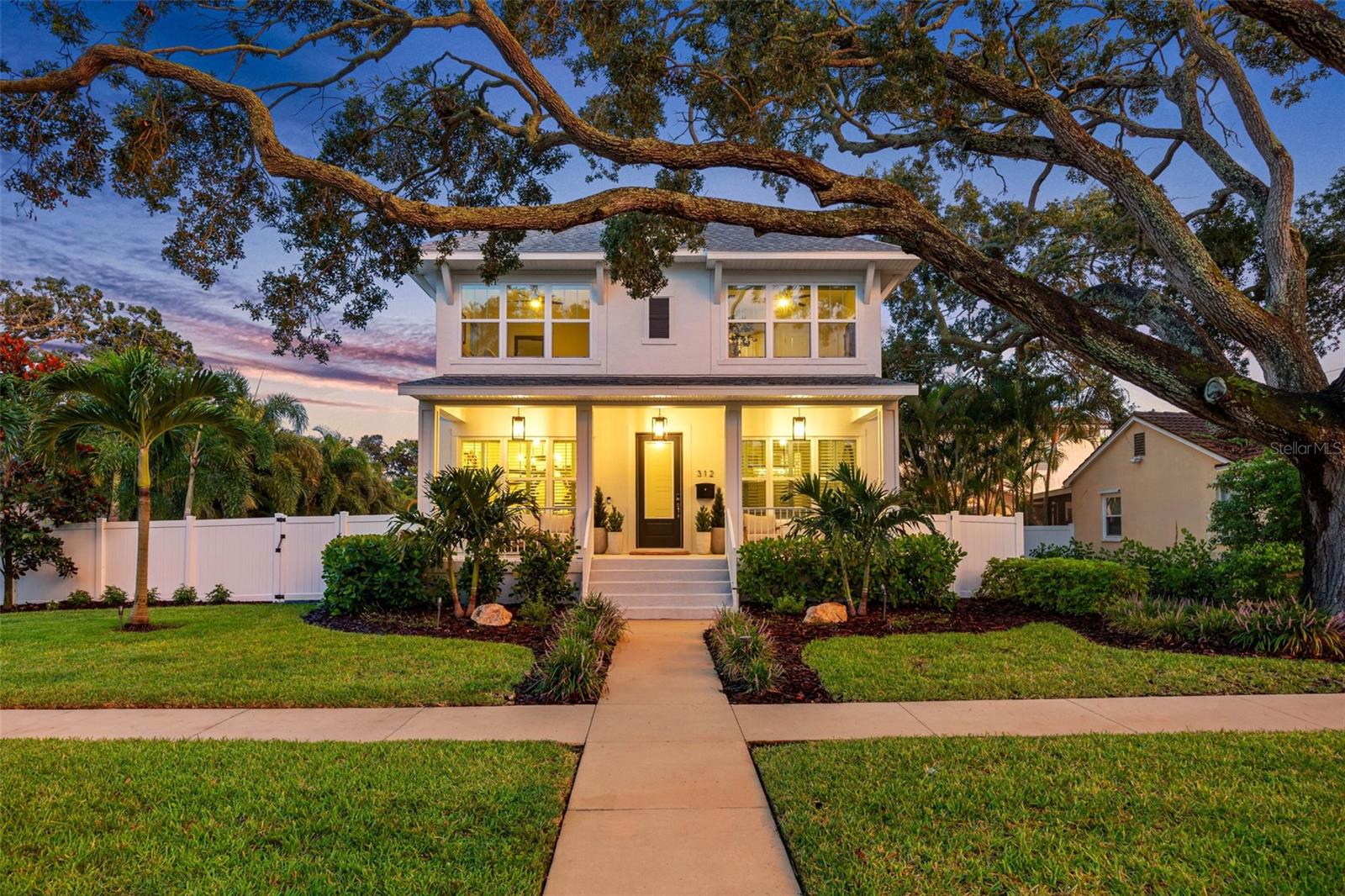 In the coveted Greater Old Northeast neighborhood, just moments from the vibrant energy of downtown St. Petersburg, stands a home that perfectly bridges eras—a newer construction estate, built on 1.5 lots that has embraced the romance and warmth of Old Florida. From the street, its inviting façade and lazy front porch feel like a scene from a simpler time, ready for cool fall evenings with friends, a glass of wine in hand, and the faint sound of laughter drifting into the night. Step inside and you’ll find that the charm of the past has been beautifully paired with the conveniences of today. Every detail has been thoughtfully designed—hurricane impact doors and windows bring peace of mind, while updated lighting fixtures, custom window treatments, and wainscoting along the staircase walls add a touch of timeless elegance. In the bonus room, a faux brick accent wall offers warmth and character, while the living space centers around a fireplace, creating a true gathering point for cooler nights. The kitchen is more than a place to cook—it’s a hub for connection. Here, a built-in bench with hidden storage makes the breakfast nook both practical and cozy. A reverse osmosis faucet ensures pure drinking water, while a whole-house carbon filtration system and water softener protect every drop. In the garage, an electric car charger stands ready for the future. The primary suite is a retreat, complete with a custom closet designed to fit every season in style. And if guests need their own space, the attached ADU with an exterior entrance provides flexibility for visiting family, a live-in au pair, or even a private office. Step outside, and you’ll find the heartbeat of this home: a brand-new, lighted pool and spa framed by heat-resistant porcelain decking—ready for summer days, evening swims, and sparkling reflections under the stars. Pentair systems make the lights, fountains, and heating a breeze to control, while landscape lighting in both the front and back yards creates a magical ambiance. New landscaping adds color and life, all sustained by a deep irrigation well. Technology and comfort weave seamlessly throughout: Ring exterior security cameras and doorbell, Kwikset smart front door access, Resideo whole-house A/C with a UV air purifier, and ADT security system. Every convenience has been considered, every upgrade completed with quality in mind. And then there’s the location—just minutes to Beach Drive for fine dining, wine bars, and boutique shopping; a short ride to the exciting downtown nightlife; or a leisurely bike through Vinoy Park along the sparkling waterfront. Here, you’re not just buying a house—you’re gaining access to the St. Petersburg lifestyle that blends art, culture, recreation, and community in one of Florida’s most desirable coastal cities. This is more than a property—it’s a rare opportunity to own a home that honors the spirit of Old Florida while delivering the luxuries and technologies today’s buyers expect. A home where memories are made on the front porch, in the glow of the pool at night, and during long, laughter-filled evenings with those who matter most. (HIGH AND DRY DURING HELENE!)