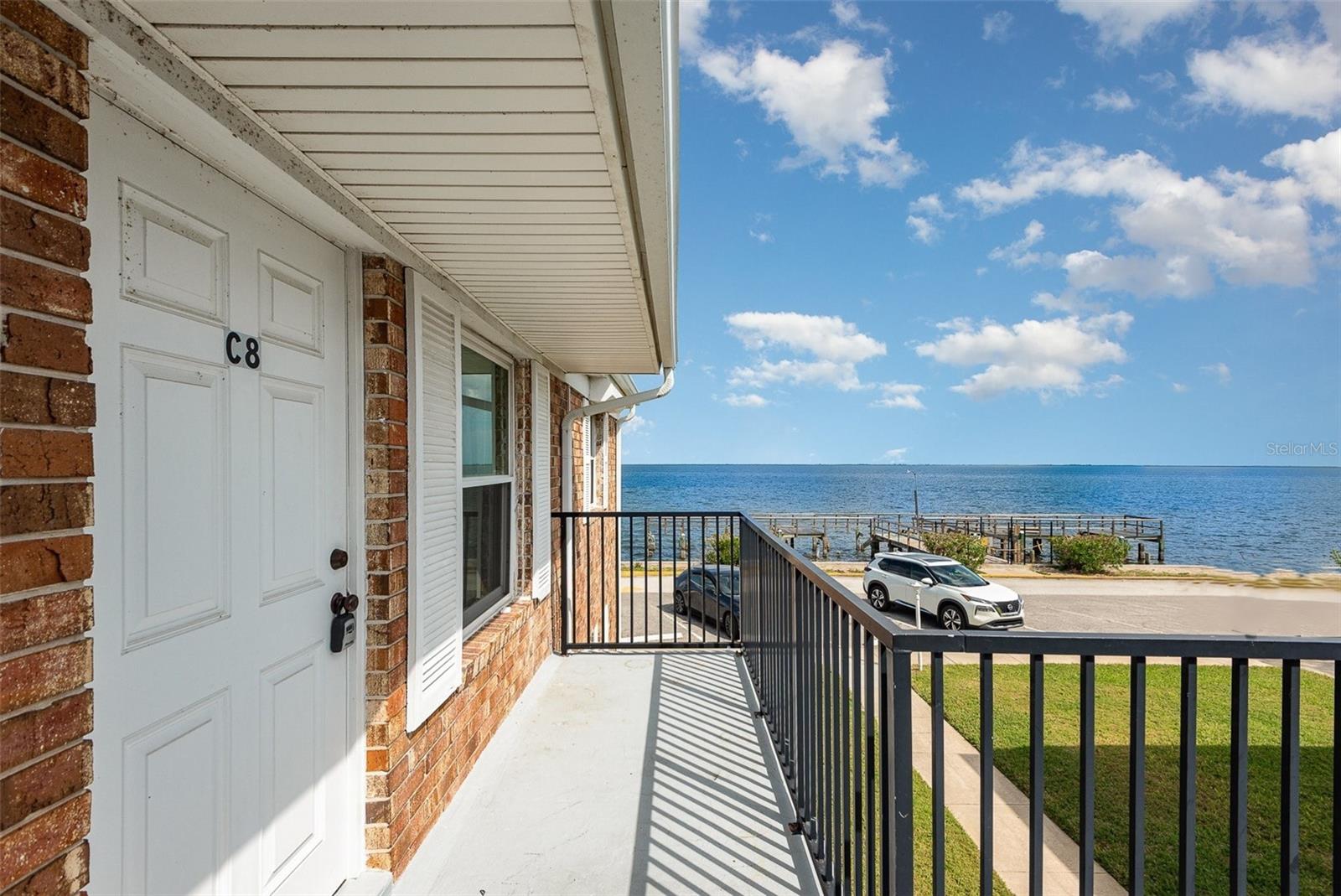 Seller will pay 8 months of condo dues at closing on this beautifully remodeled end unit directly facing the Indian River! Cheaper and less maintenance than a home living in this amazing waterfront condo. 2 full bedrooms and 2 full bathrooms. River views from both bedrooms, living room, and front and back balconies! Directly across from the VAB and the launch pads. Spectacular views of all of the rocket launches! Light and bright open interior is fully furnished if you wish! Custom cork floors throughout and tile in the bathrooms. Quality soft-close wood cabinets in kitchen and baths accented with granite countertops. Stainless appliances. All windows and doors are impact rated. Updated electrical panel. No cast iron pipes. Community has a wonderful pool and picnic area, shuffleboard, clubhouse, on site laundry, central cooling tower, community dock (being renovated), and ample fishing spots!