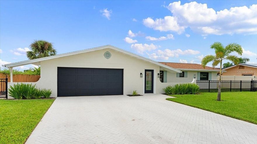 One or more photo(s) has been virtually staged. Nestled in the coastal haven of Ponce Inlet, this modern beach life residence offers the perfect blend of waterfront living, coastal charm, and a boater's dream. With direct access to the Intracoastal Waterway and the Atlantic Ocean, this concrete block home is a haven for those seeking an exquisite canal front lifestyle. Situated towards the quiet, south end of the cul-de-sac, it makes it easy to navigate quickly out to the river. A private dock with ample space for 2+ watercraft is a standout feature of this home. Enjoy the convenience of keeping your boat, kayak, or jet skis just steps away from your doorstep. A sparkling heated pool greets you along with a dancing dolphin sculpture at the end of the pool. It's perfect for outdoor dining, sunbathing, and watching the sunset over the tranquil canal waters. The interior of this home is designed with comfort and style in mind. The open-concept layout, large Andersen hurricane impact Windows & Sliders create an inviting sp ace that's perfect for everyday living and entertaining. The well-appointed kitchen features modern appliances, quartz countertops, and a family-sized breakfast island. Whether you're preparing a meal for guests or a quick snack, this kitchen has everything you need. From the family room, gaze out onto the tranquil waters and watch the evening sunsets. The front living room provides a warm cozy fireplace for those cool winter nights. The primary bedroom boasts stunning water views and offers easy access to the pool with a separate entry. The en-suite bathroom includes dual vanities & a spa tub inside the shower providing a relaxing retreat after a day on the water. Multiple bedrooms offer ample space for family and guests. This home is equipped with a two-car garage, ample storage space, and new wrought-iron fencing in the front yard so Fido can frolic in the grass safely. Ponce Inlet is renowned for its natural beauty, recreational activities, and nearby attractions such as the Ponce de Leon Inlet Lighthouse & Museum, pristine beaches, and a variety of dining options. Don't miss the opportunity to own this exceptional canal front property at 131 Anchor Drive. Whether you're an avid boater or simply seeking a serene waterfront lifestyle, this home has it all. Make it your permanent residence, vacation retreat, or investment property today. Your dream of waterfront living in Ponce Inlet awaits!