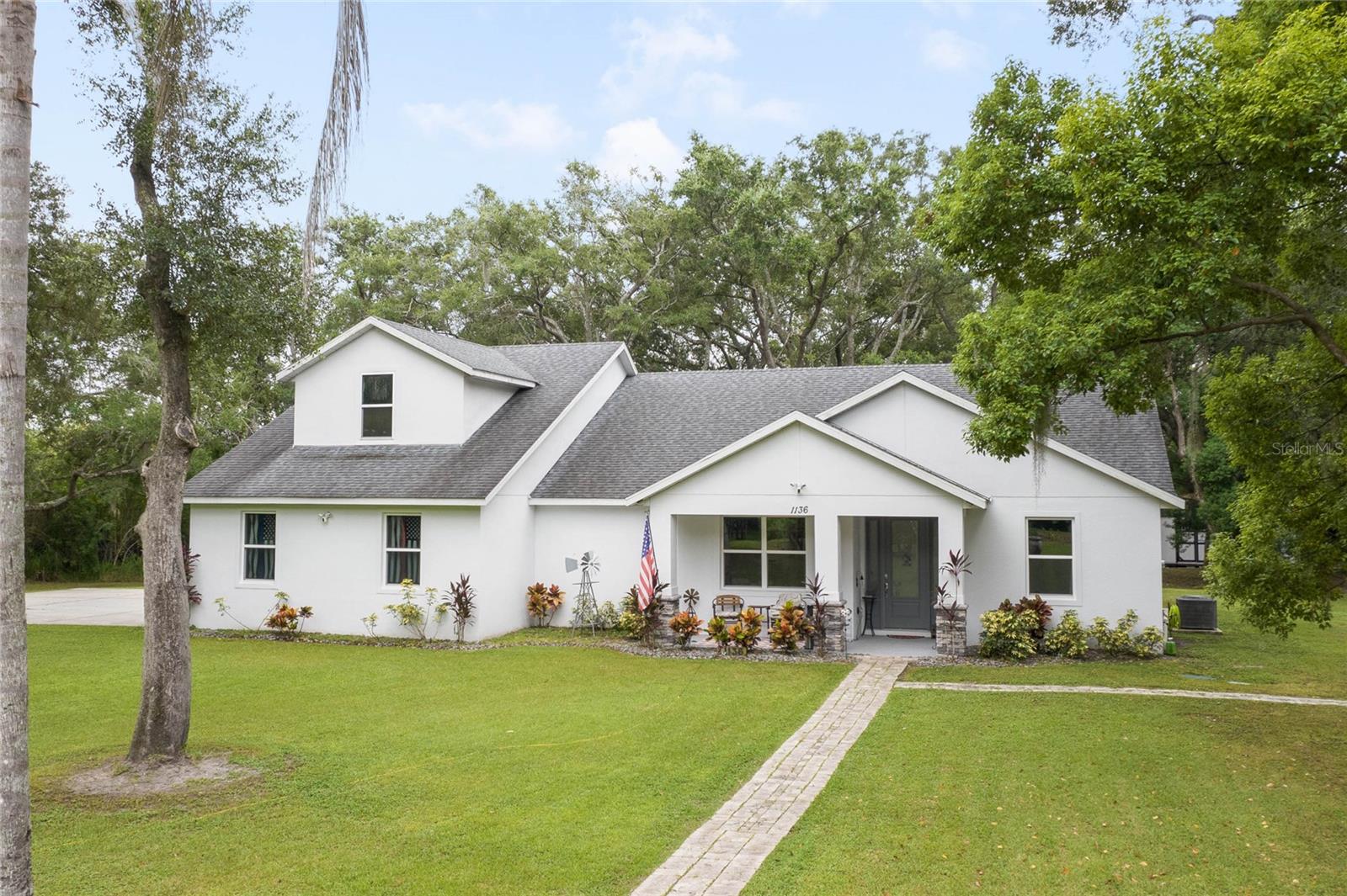 Don’t miss this rare opportunity to own almost 5 acres in the heart of downtown Winter Garden. Privacy at its best yet just a short golf cart ride to downtown for your restaurants retail therapy and fun, YES IT IN THE GOLF CART DISTRICT! 2019 custom built home sits on 4.89 acres of privacy. Two separate driveways lead to this beautiful home. This two-story home currently is a 3 bed 2 bath with unfinished space for 1 bed 1 bath upstairs. Seller will completed by closing (if buyer prefers).. It is pre-wired and pre-plumbed just needs drywall and finishings.
Enter through the front door to a spacious open plan with split bedrooms and an office with glass doors overlooking the front yard with a beautiful glass picture window. 10ft ceilings throughout . The kitchen has custom tall cabinets with crown molding, Whirlpool, stainless steel appliances, and beautiful quartz countertops. The island also has a farmhouse sink.
The primary bedroom is spacious and has a beautiful spacious walk in closet with California closet system installed. The master bath has a large shower with three showerheads one is a rain system. Two separate sinks with quartz countertops the other two bedrooms are on the opposite side of the house with a shared bathroom . Back in the large family room there are sliding pocket doors opening up to a covered back porch overlooking the backyard and wooded area to the rear for complete privacy. The front of the property also boasts a pond with aerator and a deck to sit on and overlook or fish from.
Plenty of nice, mature Oaks and lots of fruit trees compliment this beautiful private oasis.
Five years remaining on the builders warranty and also five years warranty on the HVAC system, which will transfer to the buyer. Energy star Windows. Exterior 360 camera security system will stay with the home (buyer would pay for monitoring)
Outside, you will find a large shed, chicken pen and also another larger shed for storage.
this home is across from the Tildenville Elementary School and just 1 mile from downtown Winter Garden.
The land used to be two lots, so there is a possibility you could divide back up and build another house on the property. buyer/buyers agent would need to check with the city of Winter Garden.
5 Chickens are allowed with City permit
buyer/buyers agent to check all measurements.