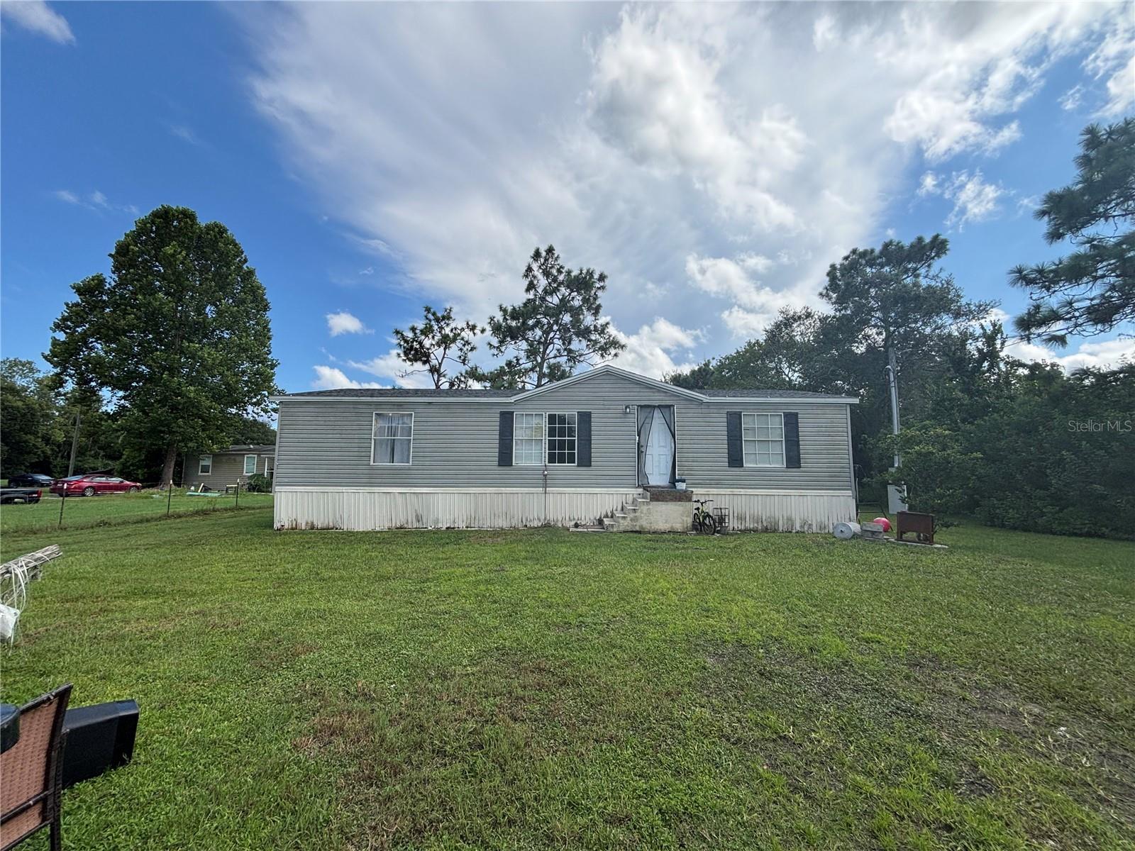 Discover country living with city convenience in this 3-bedroom, 2-bath manufactured home set on a spacious 1.19-acre lot in East Orlando. Built in 2000 and offering approx. 1,152 sq. ft. of living space, this home features an open floor plan, a bright kitchen, and comfortable bedrooms. Roof is 2 year old and plumbing is updated less than a year ago. Enjoy the large yard with plenty of room for outdoor living, gardening, or future improvements. Located just minutes from Hwy 50 and 408, you’ll have quick access to schools, shopping, dining, and Downtown Orlando—all while enjoying the privacy of a peaceful, oversized lot. Perfect for first-time buyers, investors, or anyone looking for affordable space in a growing area.