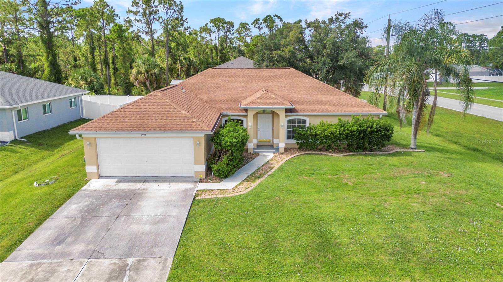 Welcome to this well-maintained 3-bedroom, 2-bathroom, 2-car garage home offering 1,858 sq ft of living space on an oversized corner lot with the convenience of city water. Step inside to find a formal dining room and a versatile bonus room perfect for a home office, den, or playroom. The home features vaulted ceilings and easy-care linoleum flooring throughout. The kitchen is a chef’s delight, complete with a breakfast bar, pantry closet, and ample cabinet and counter space to meet all your culinary needs. A cozy breakfast nook just off the kitchen offers the perfect spot to enjoy your morning coffee. The spacious primary suite boasts his and hers walk-in closets and an en-suite bathroom featuring new linoleum flooring, dual sinks, a shower/tub combo, and a linen closet for extra storage. Both guest bedrooms include ceiling fans and built-in closets and new linoleum flooring. The guest bathroom offering a single vanity and shower/tub combo and new flooring. Additional features include an inside laundry room complete with washer and dryer, and a spacious garage for storage or hobbies. Updates include Interior and Exterior paint 2025 and Roof 2022. No HOA or deed restrictions!! Conveniently located close to I 75, restaurants, shopping, beaches, and more. Ask to see this one first...make YOUR appointment today!!!