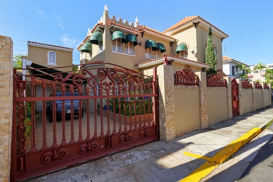 Architectural gem for  rent in Condado it can be rented furnished or unfurnished.  This Spanish Colonial Revival-style house features an impressive façade adorned with a wrought iron fence embellished with 'Flor de Lis' details, terracotta roof tiles, and arched   stained glass windows. Upon entering the foyer, you'll be impressed by the high ceilings, hanging chandelier, terrazzo floors, and the stunning wrought iron staircase leading to the second level. The two story home of 3,557 square-foot sits on a lot of 397.75 square-meter and includes on the first floor the balcony, living room, dining room, family room, kitchen,  breakfast table, a wet bar ideal for entertaining and a full bathroom. On the second level, there are 4 spacious bedrooms with 3 bathrooms. The house features an automatic 65 KLV power plant, a 60-gallon water cistern, a two-car garage, and a maid's room with its own bathroom.  Its enviable location is steps away from renowned schools such as St. John's and Robinson, supermarkets, restaurants, hotels, Antonia Quiñones Park “Parque De Condado”, Ashford Presbyterian Hospital, and a short drive from the airport. Don't miss this rare opportunity to live in this elegant Spanish Colonial Revival-style home.