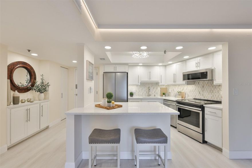 Experience elevated coastal living in this beautifully renovated 3rd-floor, 1-bedroom, 1-bath residence offering 825 square feet of intelligently designed space. Located in the sought after Southbay Condominiums, this west-facing home captures water views and breathtaking sunsets, all with the convenience of a ground-floor elevator for effortless, stair-free living.

Thoughtfully laid out and impressively spacious, the open living area features a generous living room with direct balcony access, a dedicated dining area, and a well-positioned breakfast bar ideal for both everyday living and entertaining. The 30' balcony serves as a seamless extension of the living space, perfect for enjoying evening skies and waterfront vistas.

The spacious bedroom also offers balcony access and is complemented by a custom California-style walk-in closet complete with built-in drawers, shelving, and ample hanging space—an exceptional upgrade rarely found in a one-bedroom residence. A full-size in-unit washer and dryer are housed in a dedicated laundry area with additional storage and a folding top for added convenience.

Completely renovated from top to bottom, this home showcases popcorn-free ceilings, custom coffered ceilings, perimeter lighting, elegant quartz countertops throughout the kitchen and bath and a full walk in pantry. The spa-inspired bathroom features a custom glass-enclosed shower with timeless finishes. Both the living room and the bedroom provide remote-controlled blackout curtains compatible with both Alexa and Google for effortless light and privacy control.

Recent upgrades also include a new water heater, new electrical panel, Google Nest thermostat, Ring peephole doorbell camera, brand-new hurricane-impact sliding glass patio doors, and exterior hurricane shutters for added peace of mind.
Additional features include a convenient same-floor private storage unit, same floor trash chute and one assigned underground parking space.  

This well-maintained, financially strong community offers a fully funded HOA with no current or pending special assessments, along with an on-site property manager and dedicated maintenance staff. The presence of on-site management and maintenance ensures prompt service, consistent upkeep, and long-term peace of mind.

Recent capital improvements include a renovated heated waterfront pool area, fishing dock currently being rebuilt, new roof (2025), refreshed common areas with new carpet, paint, and baseboards on each floor, lush updated landscaping, and beautifully refurbished ponds. A well maintained community clubhouse is also available for use by residents.
Association fee includes cable TV, pool, escrow reserves fund, fidelity bond, insurance, structural and grounds maintenance, management, recreational facilities, sewer, trash, and water.

Furnishings are offered separately from the sale price.

This turnkey waterfront residence delivers modern luxury, craftsmanship, peace of mind, and spectacular sunsets in one exceptional offering