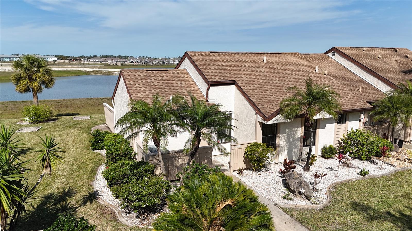 Welcome home to your lovely 2 bedroom, 2 bathroom END UNIT, single story villa that is located in one of the most affordable and sought after HOA communities in North Port the Fairway Villas. Some wonderful exterior features include: WATER VIEW, A close assigned parking spot (great for bringing in the groceries), lush landscaping throughout the community, END UNIT, and is one of the few villa's that doesn't get headlights shining in your living room when residents come and go. Once inside, the formal foyer embraces you and directs you to the main living areas. The large and spacious Great Room features soaring ceilings and ceramic tile floors throughout making cleaning a breeze and pet friendly! The kitchen boasts an abundance of cabinet and counter space, breakfast bar, plant shelves and BONUS - All the appliances are included in the sale! Completing this space, is an inside laundry room with newer washer and additional storage options. The kitchen flows seamlessly into the dining room, providing plenty of space for entertaining or unwinding after a busy day. The master suite is large in size and features a private closet and an en-suite master bath complete with shower, vanity and toilet. The guest Bedroom allows privacy for guests or family by featuring a Jack 'n Jill Bathroom with Tub and Shower. From the dining room area, step through the sliding glass doors out onto your extended, screened in, covered lanai with Vinyl Windows, the picture perfect spot to enjoy your morning coffee or entertain friends in the evening for cocktails. Next to the Lanai, there is an open Patio if you like to BBQ or want to just relax on your lounge chair and take in the GORGEOUS LAKE VIEW, and beautiful sunsets! This villa is part of a well-maintained community with low HOA fees, making it a cost-effective choice. It also features city water and sewer, ensuring reliable and efficient utilities. Located just minutes from US Hwy 41 and I-75, you’ll enjoy easy access to shopping, dining, and entertainment. Explore the nearby Coco Plum Shopping Plaza, local beaches, golf courses, and Wellen Park’s Town Center. For sports fans, you're only a short drive from the Atlanta Braves Stadium. Don't wait, this is a "Must See", and soon you will have your own slice of Florida's Paradise.