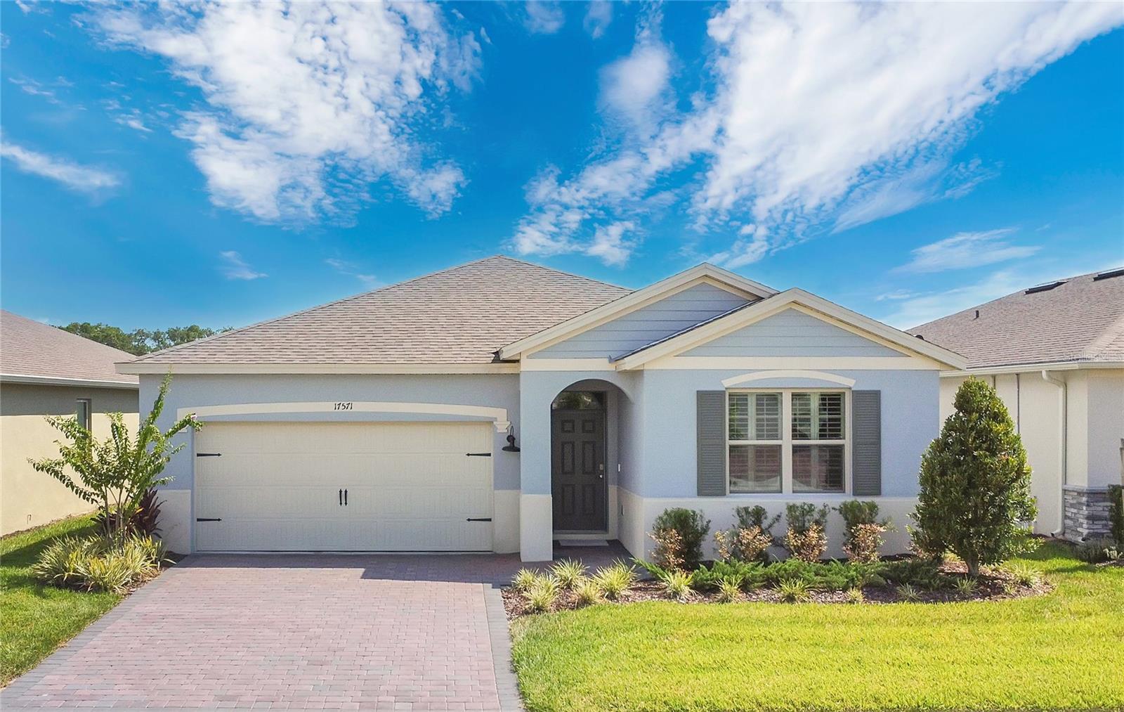 Welcome home to a light-filled water front retreat where comfort meets function. As you walk through the front door, you're greeted by warm wood-look tile floors and a bright, open layout. To your left, the kitchen catches your eye—quartz countertops, 42" crisp white deluxe cabinets, stainless steel appliances, and a classic subway tile backsplash create a space that’s both stylish and practical. Imagine cooking here, with guests relaxing just steps away in the open living room filled with natural light from the large sliding glass doors. Step out onto the screened-in lanai and enjoy quiet mornings, cool evening gatherings, or simply soak in the Florida breeze and pond views. The layout offers a thoughtful split floor plan, with the primary suite tucked away for privacy, complete with two spacious walk-in closets and an en-suite bath. In the front of the home, an additional bedroom and flex space with french doors provide space for guests, hobbies, or working from home. Smart features, like the keyless entry, camera doorbell, thermostat, and Deako interchangeable switches add convenience and peace of mind to your daily routine. Beyond the home, residents love the active adult community of Palms of Serenoa for its resort-style amenities including a secured gate, clubhouse, zero-entry pool, fitness center, dog park, and walking trails, cable TV, internet, and lawn care included! Located near shopping, dining, Disney, and the future Olympus project, it’s easy to see why this community is such a draw.