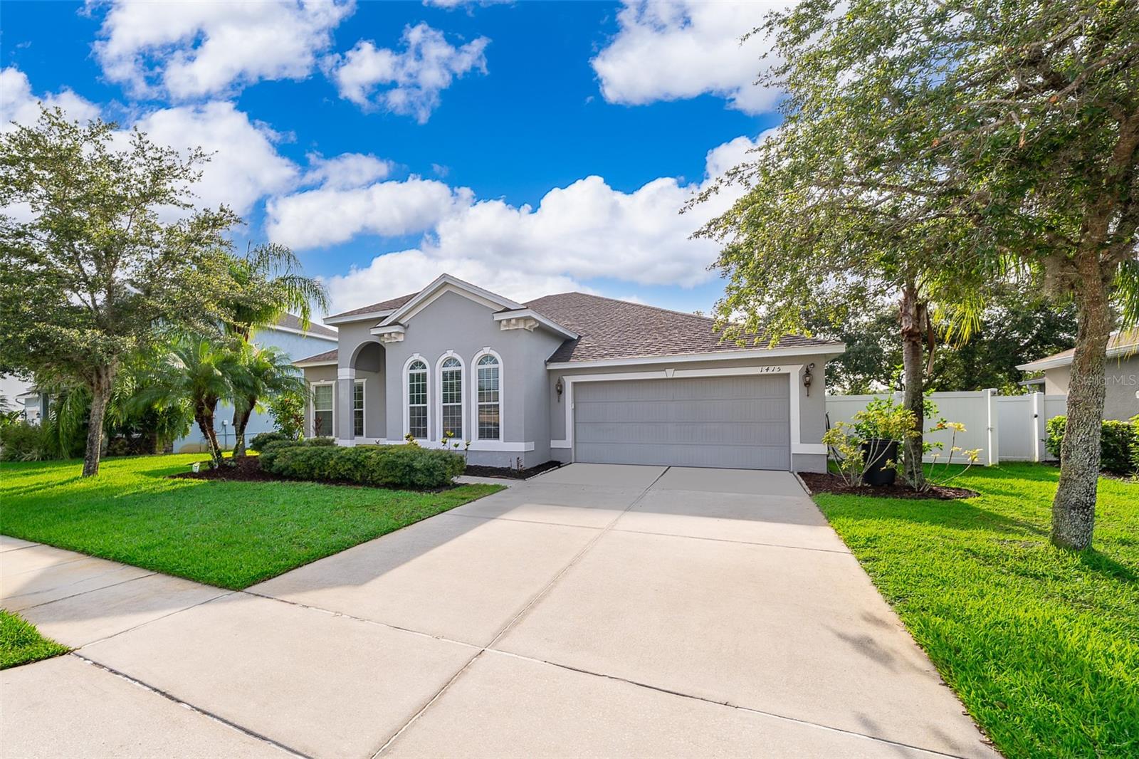 Experience the best of Oviedo living in the private, gated community of The Preserve at Lake Charm. This meticulously maintained, move-in-ready home offers an ideal blend of style and comfort. Step inside to an inviting open floor plan, where elegant luxury vinyl flooring and high ceilings create a spacious and airy feel.
The heart of the home is the stunning kitchen, featuring 42" cabinetry, gleaming granite countertops, a large breakfast bar, and brand-new stainless steel appliances—perfect for both everyday meals and entertaining. Adjacent to the main living area, a dedicated office/den provides a quiet space for work or study.
Unwind in the expansive owner's suite, a true retreat with its own relaxing sitting area and a massive walk-in closet. The luxurious en-suite bathroom fully renovated in 2022 boasts a spacious walk-in shower and a private dressing area. Two additional bedrooms are thoughtfully located on a split plan for maximum privacy.
Enjoy outdoor living in the fully fenced backyard, accessible from the covered rear patio. The home's curb appeal is enhanced by a freshly painted exterior, durable architectural shingles, and a paver driveway and front porch.
Convenience is key, with a new washer and dryer included and a two-car garage. Located in a highly sought-after neighborhood with top-rated Seminole County schools, this exceptional property is a must-see!