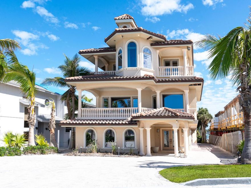 Designed by renowned architect George Merlin and built in 2006 by Christner Brothers to hurricane-resistant building code, this home rests securely on concrete-driven pilings and exudes unparalleled quality. Watch the sunrise over the Intracoastal Waterway from the deepwater boat dock and lift. Spend the afternoons on your private beach along the sandy shore of the gulf where spectacular sunsets are almost guaranteed. Inside nearly 8,000 square feet, five bedrooms with en suites, nine baths, formal living, family and sitting rooms, dual private offices, den and a theater room provide seemingly endless enjoyment. Crown molding, trayed ceilings, travertine flooring, three fireplaces and Yoder Brothers custom cabinetry exude elegant touches throughout. An elevated lagoon-style swimming pool is great for a cool dip or relax in the heated spa and outdoor fireplace on a chilly evening. The gourmet kitchen is large enough to host an impressive dinner party and gather with family and friends. Casey Key is a place like no other, where residential homes line the shores, absent of commercial building and high-rise condominiums. Development is restricted to single-family homes, yet all conveniences of shopping and restaurants are minutes away. Private and commercial air travel are easily accessible. Sports and cultural entertainment enthusiasts will find golf, tennis, theaters, music and more, just a few miles away in nearby Venice and Sarasota. There’s something for everyone in this gulf to bay resort-style home.
