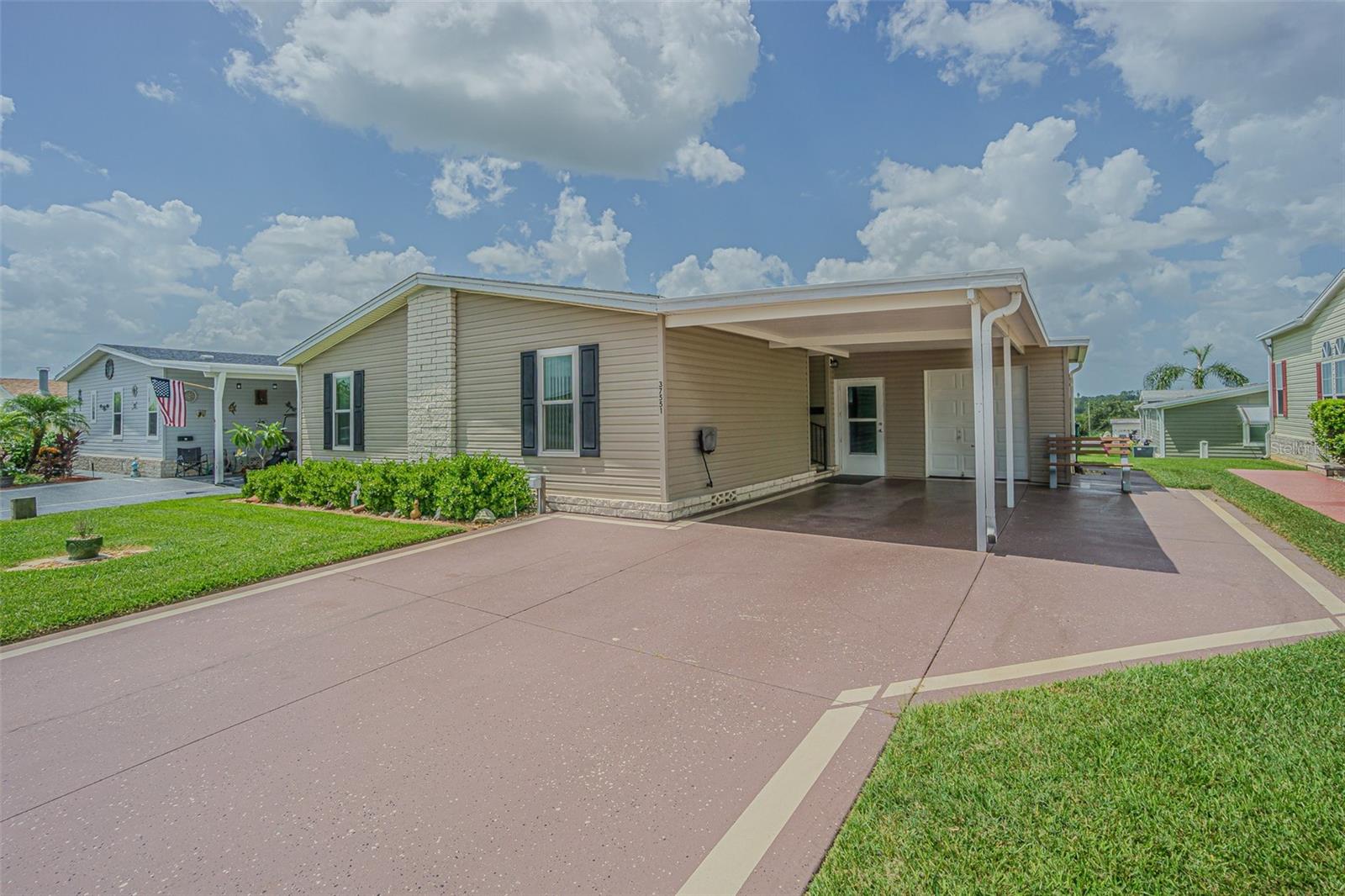 Welcome to GATED Grand Horizons, the Premier 55+ community in the rolling hills of Zephyrhills, where you OWN your LAND and enjoy resort-style living with low HOA fees and no CDD! This Light, Bright, and OPEN concept Jacobsen-built home features 3 spacious bedrooms, 2 full baths, and is perfectly situated on the highest street in the community offering refreshing hilltop breezes and scenic views. This ONE OWNER home has been lovingly maintained and thoughtfully upgraded, including double-pane windows for energy efficency, durable Shaw waterproof flooring, a 2020 dimensional shingle newer ROOF, newer water heater, water softener, and stylish 2020 stainless and black kitchen appliances with smooth top range. Comfort and efficiency are enhanced with updated ceiling fans, lighting, raised commodes plus an inviting enclosed Florida sunroom with acrylic slider windows and a wall-unit A/C... your perfect retreat to relax and unwind. Curb appeal shines with a beautifully landscaped lawn, widened driveway allowing side-by-side parking and a covered carport. Also a dedicated golf cart path leads to a golf cart garage that includes extra storage and a workbench—ideal for hobbyists and tinkerers! Grand Horizons offers an active lifestyle with a resident-owned, concrete block and stucco clubhouse featuring a commercial-grade kitchen, billiards, craft room, library, and regular community events like potluck dinners, entertainment nights, golf cart parades plus planned excursions. Gates close dusk to dawn with Private streets to drive your golf cart. All this just minutes from shopping, dining, medical facilities, bowling, movie theaters, the YMCA, and the Sarah Vande Berg Tennis Center... plus easy access to Wesley Chapel, Tampa, Orlando, St. Pete, Lakeland, Ocala, airports, and Florida’s beautiful beaches. CALL TODAY to make this exceptional home in Grand Horizons...yours!