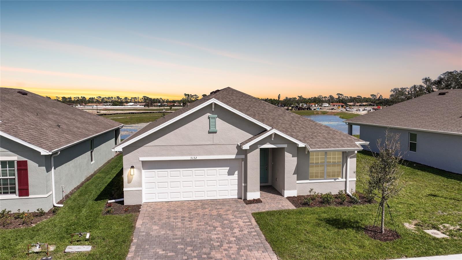 One or more photo(s) has been virtually staged. Welcome to your dream home in the highly sought-after, gated Central Parc community by D.R. Horton! This beautifully designed 3-bedroom, 2-bathroom home offers 1,672 sq. ft. of living space under air and a 2-car garage, all within a resort-style setting with low HOA fees.
Step inside to find 9'4" ceilings and stylish ceramic wood plank tile flooring in the main living areas, while plush carpet adds comfort in the bedrooms. The open-concept floor plan is perfect for modern living, with a bright and airy feel accentuated by a transom window over the front door.
The heart of the home is the well-appointed kitchen, featuring stainless steel appliances, quartz countertops, recessed lighting, and an oversized island with seating—perfect for entertaining.
The spacious primary suite boasts a large window with a serene lake view, a generous walk-in closet, and a spa-like ensuite bathroom complete with a dual sink vanity and a beautifully tiled walk-in shower. The split floor plan ensures privacy, with two additional bedrooms and a second bathroom featuring a tub/shower combo with tiled walls.
Living in Grand Parc means access to top-tier amenities, including a clubhouse, resort-style pool, fitness center, pickleball courts, and tennis courts. Plus, your low HOA fee covers amenity maintenance, association management, lawn care, and common area insurance—offering a maintenance-free lifestyle.
Don’t miss your chance to own this gorgeous new home in North Port’s premier gated community. Schedule your private tour today!