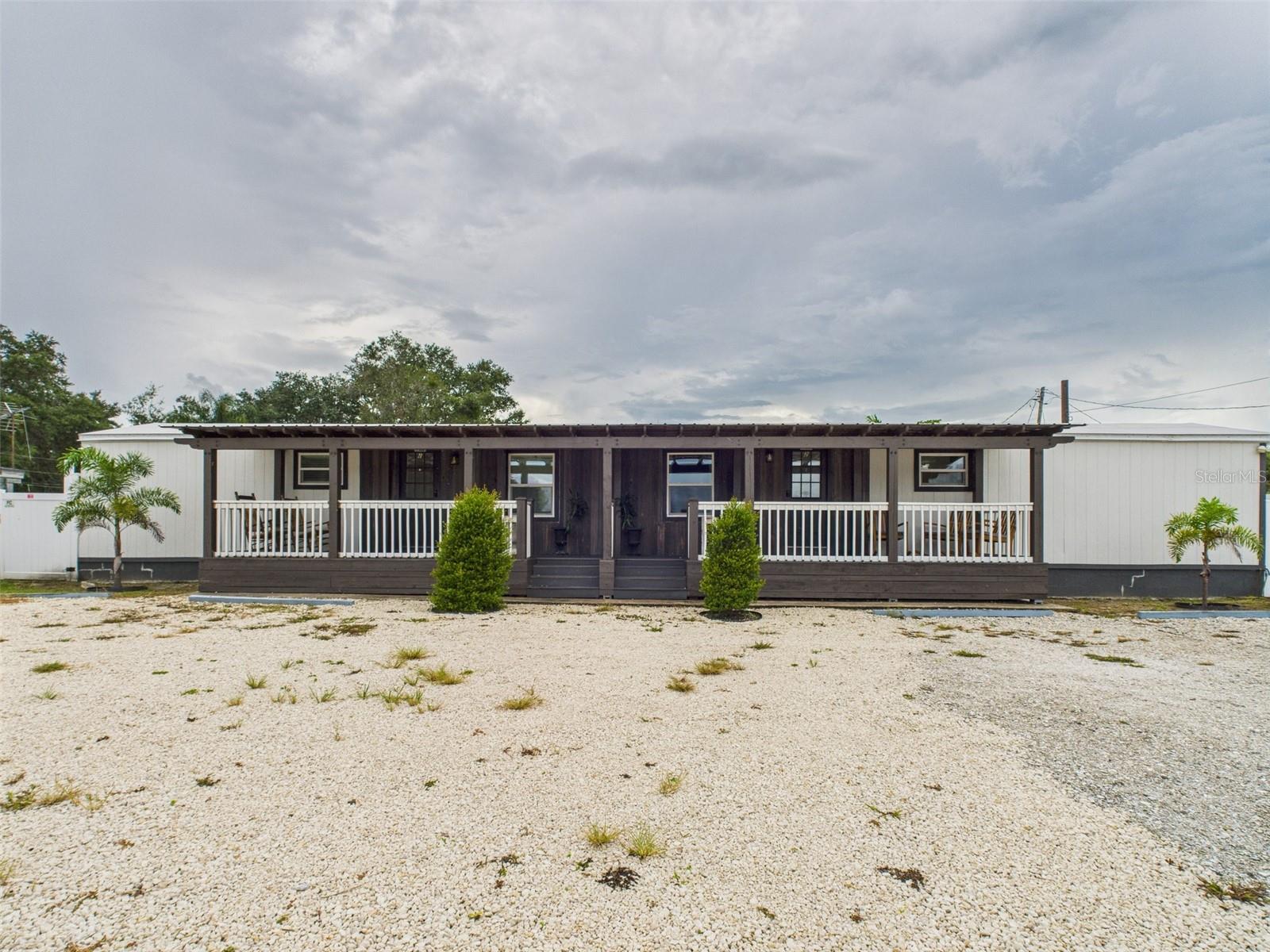 INVESTOR SPECIAL! THREE SEPARATE SHORT TERM RENTALS! Beautiful 3BR 2BA property in Davenport, FL is a perfect investment opportunity. It has been subdivided into two rental units plus a luxury tiny home to maximize income potential. The property features a charming modern design throughout and was renovated with attention to detail to appeal to AirBNB and short-term rental guests. Enjoy a covered wraparound porch for relaxing mornings, a covered outdoor deck for chilling and drinking coffee, and a backyard courtyard with a beautiful lounge area, all surrounded by durable white vinyl fencing for added privacy. There’s also extra storage space in the outdoor shed, which conveys with the property. Inside, you’ll find spacious showers with built-in shelving, modern hardware and lighting, shiplap and Victorian wood paneling, an indoor laundry room, and more. Conveniently located near grocery stores, restaurants, and services, and just over an hour from beaches on both the Atlantic and Gulf coasts. Don't miss out on this unique INCOME-PRODUCING property! Seller financing and private financing available. Don’t wait...this one WILL NOT last long! 3D Virtual Tour here: https://tour.giraffe360.com/bb1c1c6fc2174007a8e53c923d1d179a/