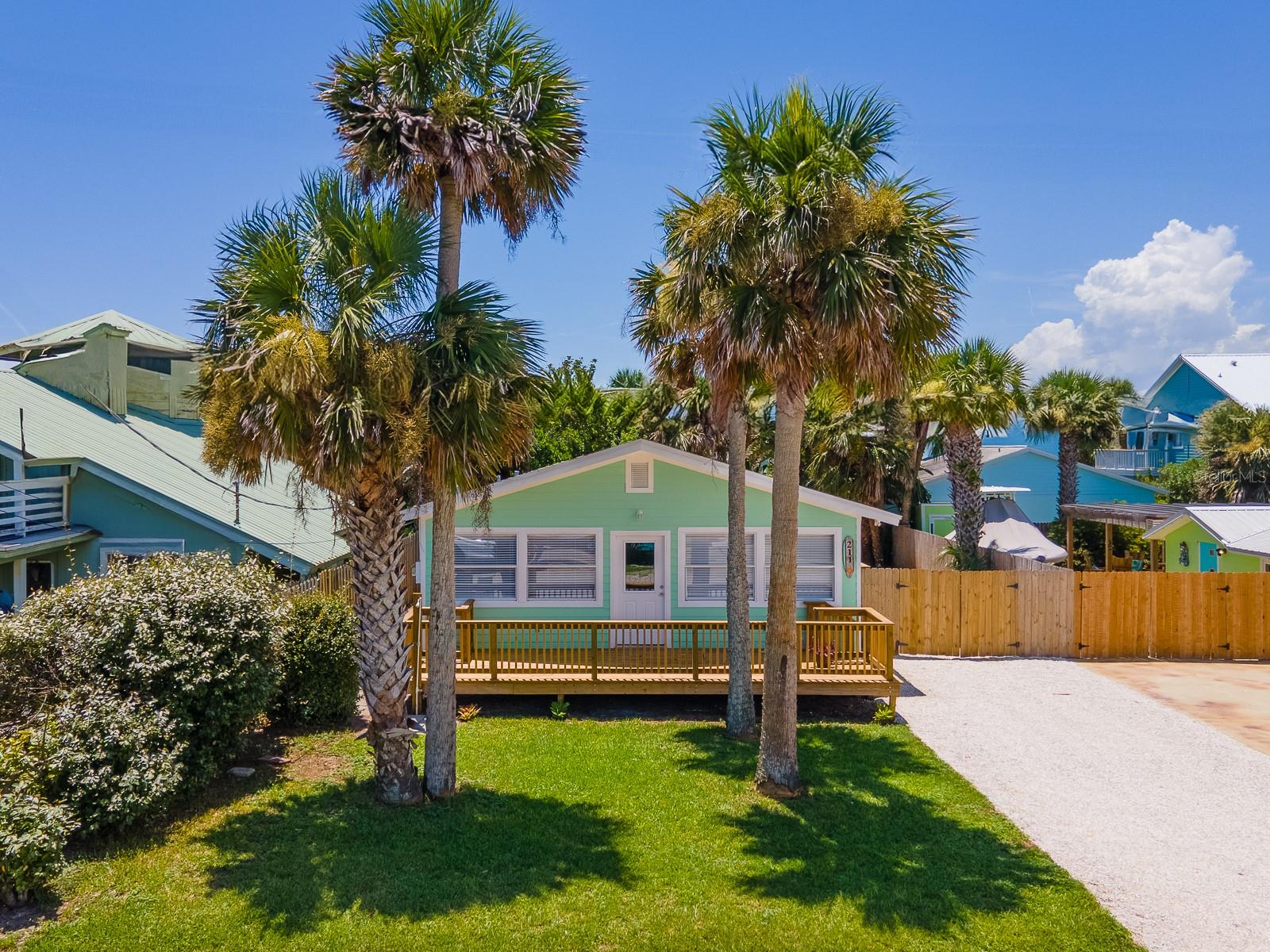 CLASSIC in town BEACH BUNGALOW! This adorable home just got a full interior modern remodel and is just STEPS from the BEACH! Located in the heart of town on a high and dry no-flood X zone lot. No short-term rentals, call about details. Enjoy everything Flagler Beach has to offer within easy walking distance - Betty Steflik Preserve on the Intracoastal Boardwalk, the crown jewel of the area, with tennis, pickleball, basketball, a tot lot and a Saturday Farmer's & Craft Market, the beach boardwalk, the new Flagler Pier (currently under construction), and last but not least - the beach! The lifestyle in this community is laid back friendly and as casual as flip flops and bathing suits. Walk to dozens of one-of-a-kind eateries and shops, cycle everywhere or hop on a golf cart to get around - you'll need a car just for trips over the bridge for grocery just 1.5 miles away. Enter this home from the new front deck into a light and bright living area. New plank ceramic tile flooring was installed throughout the home. The bathroom sports charming, new retro-style black and white tile on the floor and sleek fixtures, including a double sink vanity. The kitchen features brand-new stainless-steel appliances, a lovely marble countertop with an undermount stainless sink and solid wood, soft close cabinets. Two generously sized bedrooms are at the rear of the home. The backyard is ready for your personal vision – it is spacious and private with a high wood fence, accessed from the main living area inside and from a double gate to the driveway. Flagler Beach is centrally located between historic St Augustine and exciting Daytona Beach, and only 3 miles from I-95. Check out this gem of a beach house in this gem of a beach town!