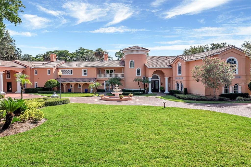 One or more photo(s) has been virtually staged. This magnificent estate was originally built in 1938 with a major addition in 1999. The estate is nestled on nearly 2 acres of prime property on Lake Maitland on the Winter Park Chain of Lakes and walking distance to all the shops and restaurants on Park Avenue. As you drive up to the estate, you will be impressed by the entry gate that leads to the huge circular paved driveway complete with a fountain. For the car enthusiast, there are 2 separate garages totaling 7 spaces. There is plenty of additional parking as this house was built for luxury living and entertaining! The home spans 19,304 square feet under air and 25,124 square feet under the roof. There are two separate grand foyers to welcome you, with high ceilings, gorgeous staircases, and magnificent lake views. This home was built to showcase the stunning lake views from almost every room. There are multiple patios and balconies to offer the perfect spots to take in the incredible views. With a total of 8 bedrooms, 3 of which are master suites with ensuite bathrooms and massive walk-in closets there is no shortage of space in this home. In total, there are 9 full baths and 5 half baths making sure everyone has plenty of space in this Park Avenue Estate. Plus, there is a caregiver’s suite with private entries for live-in help. This home is equipped with 3 kitchens making any large gathering a breeze to accommodate! As well as 3 elevators so everyone can move about the estate with ease. The expansive estate is perfect for a multi-generational family, with plenty of bedrooms and bathrooms for everyone to comfortably live together. The grounds are simply beautiful, with mature landscaping and expansive lake views there is truly nothing like it. The possibilities are endless with this home! If you are looking for a one-of-a-kind property, this is it! The grandeur of this estate and its prime location makes it a truly unique find. Don’t miss your chance to own a piece of Winter Park history!