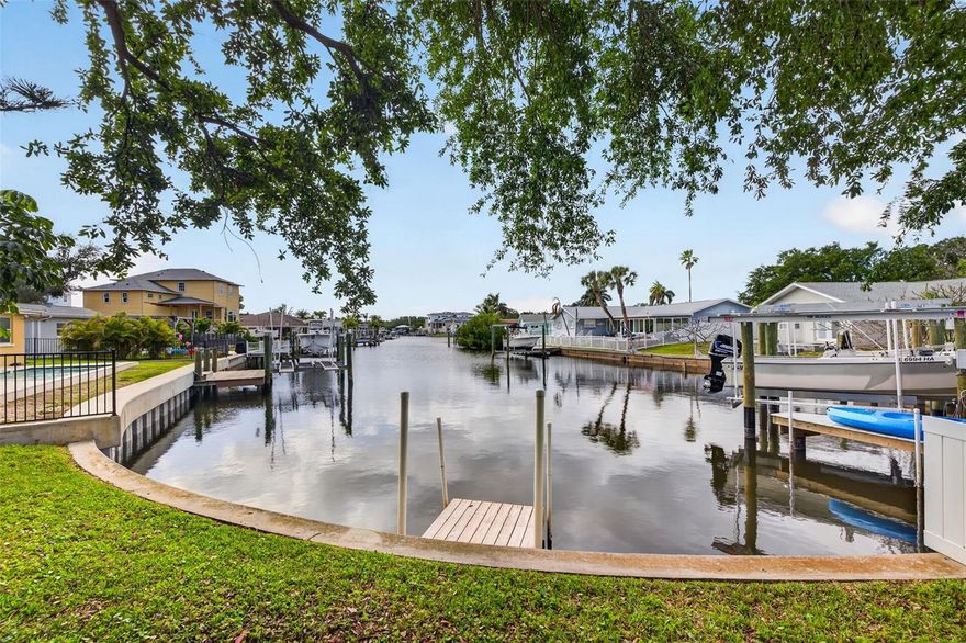 Welcome to one of Northeast St. Pete's most genuinely rare waterfront opportunities — a 4-bedroom, 3-bathroom, 2,500 square foot executive home in the beloved waterfront community of Ponderosa Shores. Picture this: Morning coffee in hand, you glance through the wall of rear-facing windows and catch that long, glassy canal stretching straight out from your backyard. A manatee rolls near the dock. A pelican glides past. You're not on vacation — this is everyday life here. What sets this home apart is how you see the water. Unlike most canal homes that stare into a neighbor's yard, this residence delivers unobstructed, long-range views straight down the canal — privacy, serenity, and a visual runway that never gets old. Step through the rear doors to your waterfront paradise and watch dolphins and manatees play from your private floating dock. With no low bridge restrictions, you have direct big-boat access to Tampa Bay and the Gulf — island hopping, fishing, and sandbar days start right in your own backyard. The home has been thoroughly updated: New Roof (2024) · New Elevated HVAC (2025) · New Water Heater (2025) · Upgraded Electrical · Fresh Paint Inside & Out · Hurricane Storm Shutters. The open-concept layout flows beautifully, with a flexible office/den, full utility room, and interior laundry. A fireplace just off the dining room sets the perfect cozy tone on cool Florida evenings. The kitchen is a blank canvas — ready for your dream gourmet build. Add a pool and boat lift on the quarter-acre-plus oversized lot and you have an estate that's truly your own. The Ponderosa Shores neighborhood delivers a lifestyle to match — golf-cart friendly streets, the Shore Acres Holiday Parade, and a quick bike ride down the Northeast Trail straight into Historic Vinoy Park and Downtown St. Pete. World-class dining, the Dalí Museum, the St. Pete Pier, craft breweries, and waterfront parks are all minutes away. 2,500 Square Foot, Four Bedroom Waterfront homes with this canal positioning, this lot size, and no bridge restrictions are genuinely rare. Schedule your private showing today.
