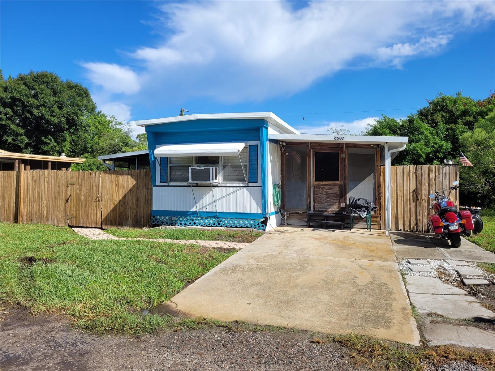 A tucked away 2-Bedroom, 1-bathroom mobile home where you own the land, with no HOA fees! Nice large kitchen with a gas stove (rare in Fl.) with a dining room area in the kitchen. An inside storage room area off the kitchen, 2nd bedroom has washer and dryer connections, new waterproof vinyl flooring throughout, and a new water heater. Lots of outdoor spaces to enjoy with 2 Lanai's (1 in front & 1 on the side, and a back covered deck. The Shed /Workshop has electric and additional storage. Convenient location to shopping, restaurants, entertainment, sports, medical, beaches, parks, marinas, and airports.