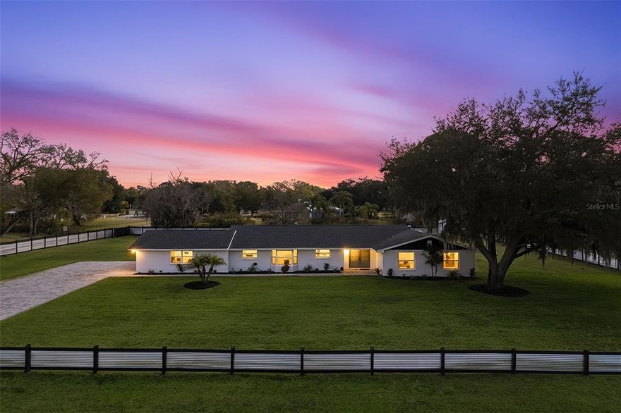 Luxury living meets modern design in this one-of-a-kind estate nestled on over an acre of beautifully landscaped land in the heart of Lutz, Florida. Welcome to 2338 Meadowbrook Drive, where every element of this property has been thoughtfully transformed to create a private, resort-style retreat unlike anything else on the market. Drive through your new aluminum fencing with coded access gate and immediately feel the difference, this is a home that impresses from the moment you arrive. The paved circular driveway, meticulous fresh landscaping, and stylish exterior paint set the tone for what awaits inside. With a new roof (2022), new windows (2021), this home offers peace of mind along with dazzling curb appeal. Step inside to a bright, open-concept floor plan that embodies elegance and comfort. The interior has been fully remodeled top-to-bottom, featuring rich luxury vinyl plank floors, designer finishes, and fresh interior paint throughout. The chef’s kitchen is the heart of the home, with brand-new stainless steel appliances, sleek modern cabinetry, quartz countertops, and a spacious island perfect for entertaining. Every corner of this home feels elevated, from the updated lighting to the clean, cohesive design that flows seamlessly from room to room. But where this property truly shines is outdoors. Your backyard is a private resort oasis, designed for year-round enjoyment and effortless entertaining. Take a dip in the brand-new heated saltwater pool, relax beneath the stars by the custom fire pit and seating area, or host unforgettable gatherings in your outdoor kitchen complete with built-in grill and prep space. The dedicated full outdoor bathroom makes pool days a breeze, while the large grassy yard and surrounding landscape offer endless opportunities, from family play spaces to adding future guest quarters. Practicality meets luxury here: an outdoor storage shed provides extra space for equipment, while the vast acreage gives you the freedom to breathe, expand, and truly enjoy your surroundings. It’s rare to find over an acre of fully fenced, usable land combined with such high-end renovation work in a highly desired Lutz location, offering both seclusion and convenience just moments from top-rated schools, shopping, dining, and the Veterans Expressway. Every big-ticket item has already been handled, allowing you to move in and start living the life you’ve envisioned. With its perfect blend of modern upgrades, outdoor elegance, and private space, this property sets a new standard for luxury living in Lutz. Opportunities like this don’t come around often, schedule your private showing today and experience firsthand everything this dream home has to offer. Act fast, homes this exceptional never stay on the market for long!