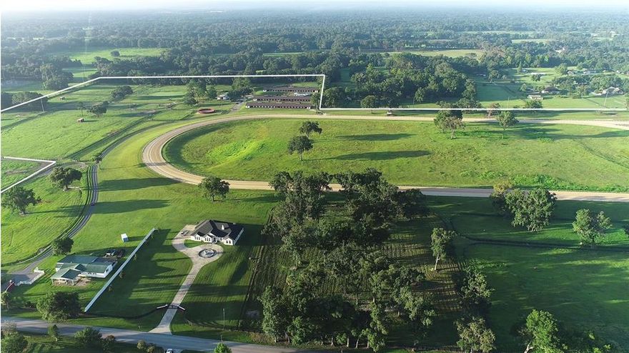 Located in the prestigious NW Marion County area, just 8.5 miles to the World Equestrian Center with easy access to I-75 for traveling, plus convenient to additional amenities.  A property that is a must see to appreciate all the beauty and features it has to offer.  80+/- Acre, State of the art equestrian facility with main residence and guest/ employee housing, 4 barns - 104 stalls, ¾ +/- mile racetrack, Eurociser, round pen plus plenty of lush green paddocks. 
This estate includes a 4 bedroom, 3 bath home, built in 2016 with over 3,700 SF of living area.   Open floor plan is light and airy.   Formal living has double sided, wood burning stone fireplace, built in bookcases, family room, formal living room, formal dining room, kitchen, plus recessed ceilings throughout main living areas.   Kitchen features custom cabinets, granite countertops, walk in pantry, stainless steel appliances plus a cooktop.  Raised countertop seating area in kitchen.  Family room and dining area with double recessed ceiling, large windows, and access to the rear patio.  Spacious owner’s suite with ensuite bath which features double vanities, Jacuzzi tub plus shower.   Second bedroom with access to full bath.  Third wing of the home has 2 additional bedrooms and 1 bath.   Attached spacious two car garage. 
The second residence has been remodeled to include two apartments for staff or guests.  
Equestrian facilities include 3 concrete block shed row barns with 32 stalls per barn which have been renovated with new paint, new roofs in 2021, clay, cupolas, and new plywood.  Each barn has office/ tack room and restroom located on west end of the barn, and LED lighting.   4 Brand new wash racks. 8-Stall center aisle wooden pony barn with metal roof.   Additional improvements include:  8-horse Kraft Euorciser with metal roof, new round pen with viewing platform, multiple shavings pits, plus loading ramp.   ¾ +/- Irrigated racetrack with starting gate, 11-zone irrigation for the track and viewing stand.     New 4 board fencing on the property.  18 Lush green paddocks and pastures of various sizes.