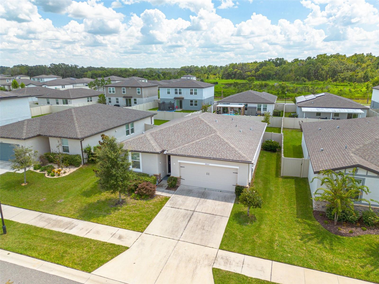 NEW TO MARKET!!! NEW TO MARKET!!! NEW TO MARKET!!!
Welcome to 38662 Finn Clover Lane, a beautifully maintained 2021-built home by Meritage Homes, perfectly blending modern efficiency with thoughtful upgrades that set it apart from the rest.
Step inside and you’ll immediately notice the bright, open floor plan designed for both everyday living and entertaining. The kitchen flows seamlessly into the dining and living areas, creating the heart of the home. With energy-efficient construction, smart design, and quality finishes, this property offers the comfort and reliability you expect from Meritage.
The current owner has enhanced the home with several standout features. A full vinyl fence wraps the backyard, providing privacy and a safe space for pets or play. The addition of an electric awning creates a shaded retreat on sunny afternoons, while the extended backyard pavered patio offers the perfect spot for grilling, gatherings, or simply enjoying Florida’s year-round outdoor lifestyle. At the front, elegant stonework accents elevate the home’s curb appeal and make a lasting first impression.
Located in the desirable community of Zephyrhills, you’ll enjoy easy access to shopping, dining, schools, and commuter routes—all while living in a quiet neighborhood setting.
This home is truly move-in ready with modern style, efficiency, and custom touches already in place.