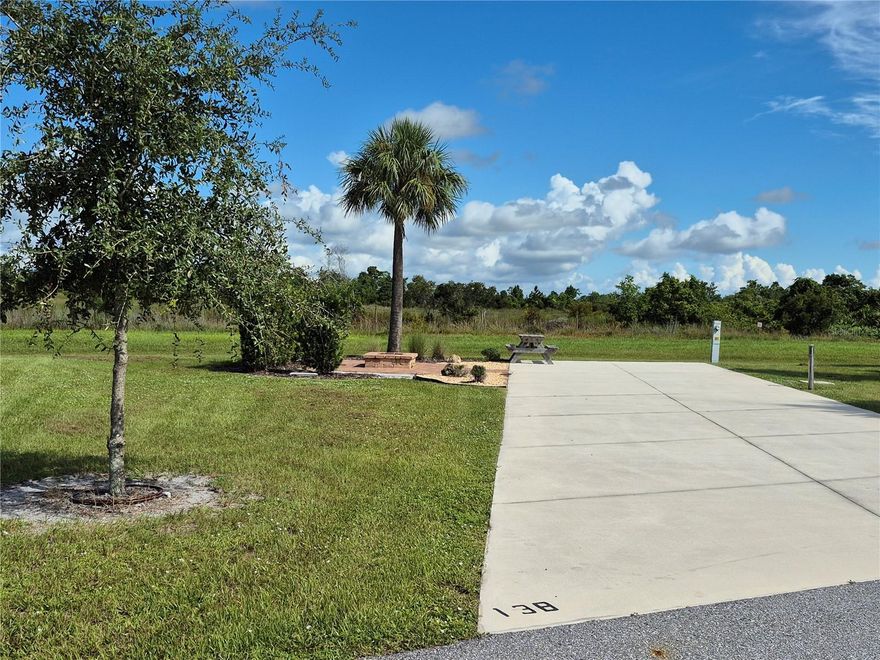 Welcome to the Resort at Canopy Oaks in Lake Wales, Florida! Surrounded by the beauty of natural Florida, this premier RV destination offers resort style amenities including a large pool and hot tub, a 12,000 sq. ft. clubhouse, full-service tiki bar, on-site café and general store, pickleball courts, shuffleboard, bocce, fishing ponds, dog parks, and picturesque walking trails. This deeded premium nature reserve site provides a peaceful, private setting with brick fire pit and pavers, and plenty of space to unwind. The generous 20’ x 70’ concrete pad features full hookups (20/30/50 amp) and easily accommodates Class A, Class C, fifth wheels, travel trailers, or even a small park model—making it the perfect carefree seasonal retreat.