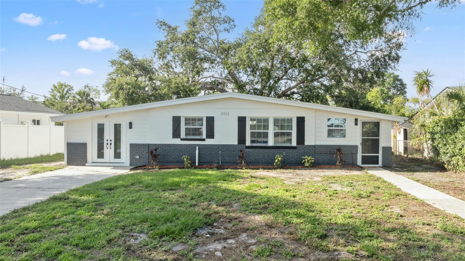 Waterfront home in this highly desirable waterfront community of Bay Crest Park in Tampa. This beautifully renovated coastal retreat offers the perfect blend of modern design and comfortable living. With 4 bedrooms and 2 bathrooms, this home spans 1,638 square feet and features an open floorplan that invites natural light and effortless flow. The kitchen is a true showstopper, featuring a sophisticated two-tone design with crisp white cabinets paired with warm, neutral wood tones, topped with stunning granite stone countertops. A farmhouse sink, modern hood, built-in microwave drawer, pendant lighting, and a dry bar with a wine rack and dual zone wine cooler to elevate the space, while beautiful tempered glass pantry doors add a touch of elegance. The primary suite is generously sized, offering a walk-in closet with custom built-in shelving and an expansive en-suite bathroom. Step into a spa-like retreat with a frameless glass shower that showcases a natural waterfall system, large black herringbone tile, and luxurious gold hardware. A thoughtfully designed split floorplan offers privacy, with two additional generously sized bedrooms and a full hall bath located conveniently nearby. Throughout the home, sophisticated luxury vinyl plank flooring mimics the look of real hardwood, offering durability and timeless charm. Step outside to a peaceful backyard oasis with new brick pavers that lead to your private dock. From here, enjoy direct access to the ocean via the Woods Creek channel—perfect for boating to local favorites like the American Legion, Bahama Breeze, or relaxing days at the bay’s iconic sandbars. This home has been professionally remediated and includes a 2023 roof, along with newly updated AC, plumbing, and electrical systems completed in 2024 with proper permits. Neighborhood boat launch available for Bay Crest residents only. Build your credit with this rental and seller is open to lease to own option. Call for details. 1st and security and pets allowed.