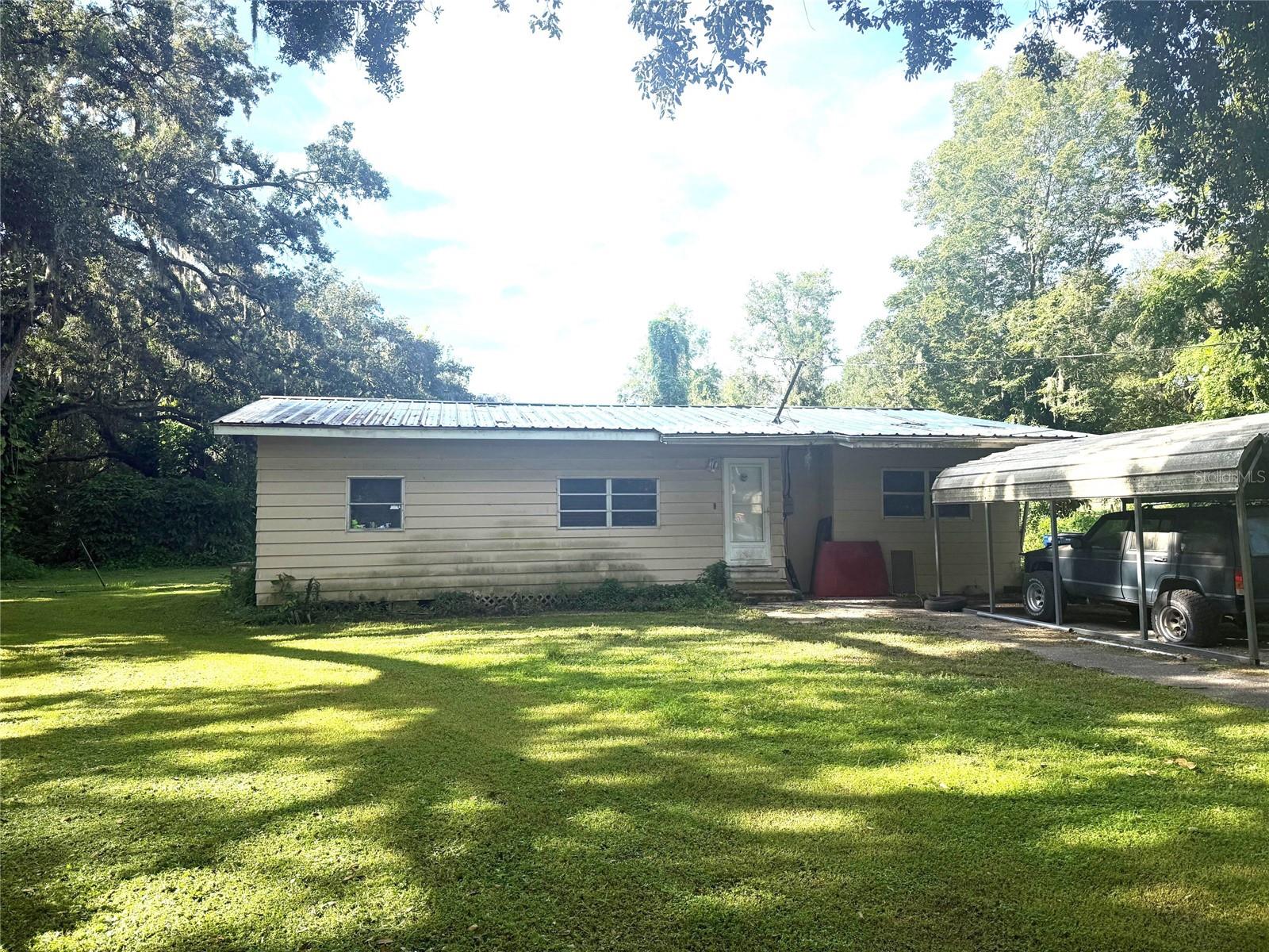 Investment opportunity / Handyman special ! Technically a 3 bedroom / 1 bath Home sits on .98 acre lot minutes from major highways, shopping and restaurants. Current long term tenant occupied paying under market rate rent. There are some updates that may be needed to get insurance on the home. Options like Tapco or Kin are options for financing. Metal roof, some electrical updates have been done. Plumbing works. Window unit ACs. On well / septic. Ask me about "Fix & Flip" style loans with 25% down or FHA 203K loans with as little as 3.5% down and you build in repairs in the overall loan. Obviously, the seller prefers a quick cash sale. NO HOA, No Deed restrictions, front room was closed in. Located in flood zone, did not flood inside