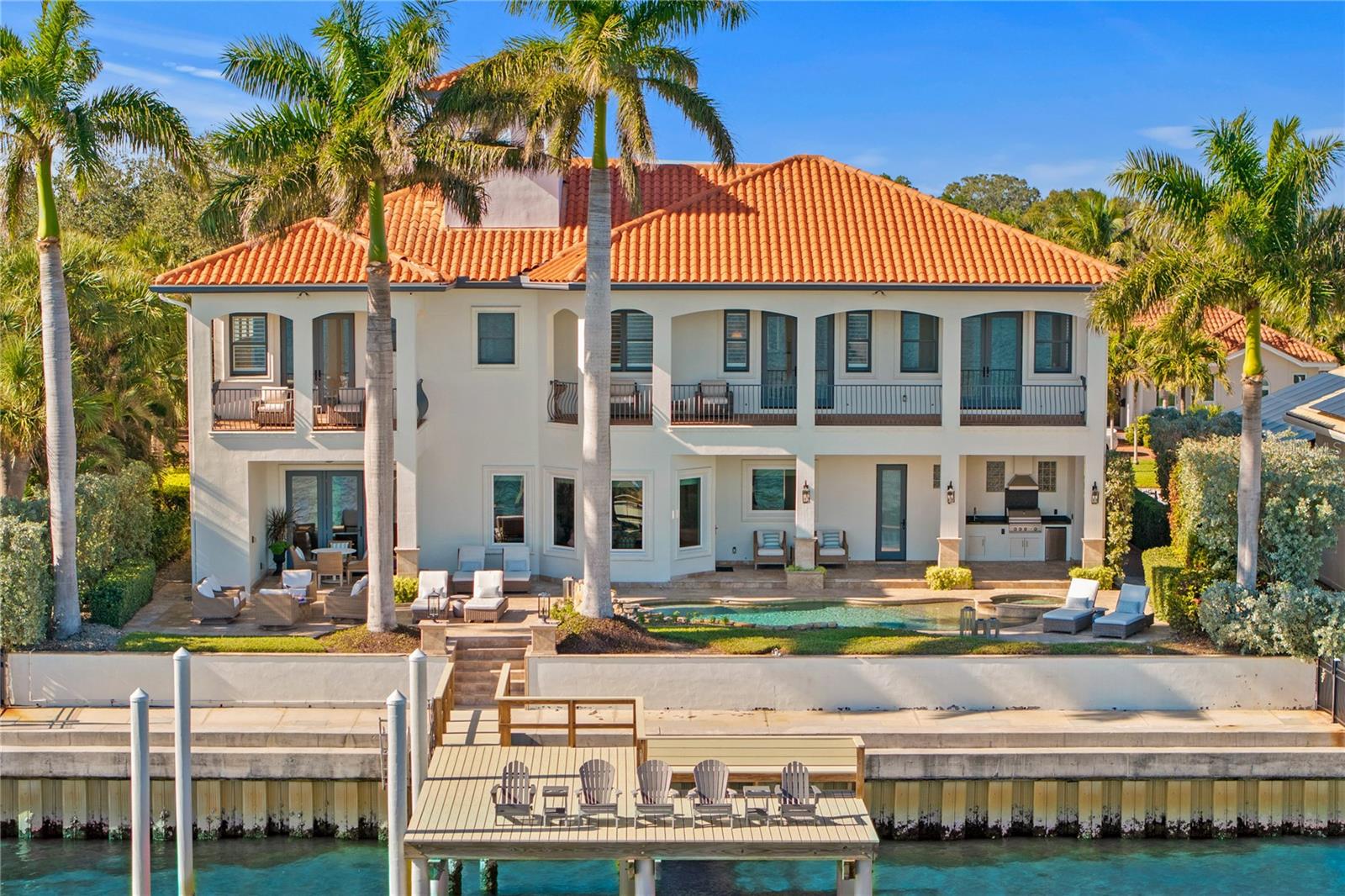 Venetian Isles modern Mediterranean estate with 90’ of dazzling deep-water Tampa Bay frontage awaits you on one of the most coveted avenues in St. Petersburg. This impressive custom residence with 4 large bedroom suites and 5 full bathrooms encompassing 4,767 sqft. was built in 2007 and showcases superb craftsmanship and materials with block construction and has been meticulously renovated to perfection with modern coastal finishes that make for seamless indoor and outdoor luxury living with inspiring water views. Modern luxury awaits you with refined and spacious living areas, an open floor plan with a grand foyer and curving staircase leading to 4 en-suite second-floor bedrooms. The stylish living and dining areas are perfect for entertaining and open to the new gourmet kitchen featuring a 48" Wolf range, double ovens, a Sub-Zero refrigerator, Scotsman nugget ice maker, 2 cooling drawers, 2 Bosch dishwashers and polished quartz countertops with a large center island and a walk-in pantry. Your guest will be impressed with the main floor massive bonus/entertainment room with water views that leads out to the resort-style backyard with lush landscaping, spacious patios, outdoor kitchen, gas fire pit lounge area, a heated saltwater pool, spa and waterfall, and the new custom dock perfect for enjoying the ultimate Florida waterfront lifestyle. The grand staircase leads you to 4 bedrooms including the resort-worthy primary suite with sweeping water views, a gas fireplace and sitting area, a large private balcony, an oversized dressing room with custom built-ins, a luxurious spa like bathroom with an oversized shower and a freestanding tub plus a large bonus room perfect for a gym, office, or nursery overlooking Tampa Bay. Three additional en-suite bedrooms plus a second story laundry room and a breakfast bar complete the second floor. The oversized 3 car garage with finished floors and custom built-in storage leads to a spacious mud room with custom shelving and a full-sized stackable washer and dryer. Additional features include a whole-house water filtration system, reverse osmosis drinking water, custom window treatments, interior/exterior sound system, Control4, central vacuum and a raised sea wall complete this sleek tropical oasis. Located minutes (by land or sea) from downtown Tampa and St. Petersburg’s shopping, dining, Yacht Club, and museums. Square footage per property appraiser, buyer to verify all measurements.