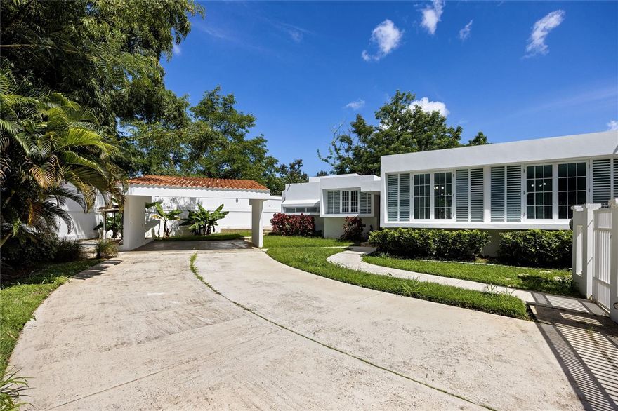 Welcome to Paseo Mayor, part of the highly regarded Los Paseos community in San Juan, Puerto Rico. This distinguished single-level residence combines elegance, comfort, and convenience, offering a lifestyle defined by privacy and sophistication.
Perfectly positioned on a generous 888.78 sq. m. lot at the end of a cul-de-sac, the property benefits from enhanced privacy, ample space for entertaining, and abundant parking options. The residence features an open-concept layout of approximately 2,773 sq. ft. of living space, designed to maximize natural light and create an inviting flow between living, dining, and family areas. A bright breakfast room connects seamlessly to the kitchen, providing an ideal space for everyday gatherings.
The home offers four well-proportioned bedrooms, including a spacious primary suite, along with 2.1 bathrooms, a dedicated laundry room, and abundant closet space. Architectural details such as a two-car carport with additional parking for up to four more vehicles within the gated driveway, and extra storage areas further enhance the property’s appeal. The expansive lot also provides opportunities to extend outdoor living areas or design a custom entertainment space.
Living in Paseo Mayor means being part of one of San Juan’s most sought-after residential communities, known for its central yet serene setting. The location provides immediate access to PR-199 and PR-52, connecting you effortlessly to Guaynabo, Cupey, Hato Rey, Caguas, and Trujillo Alto. Nearby, residents enjoy a variety of dining, shopping, schools, and recreational amenities, making this an exceptionally convenient address without compromising tranquility.
Recent comparable sales within the community highlight the strong market value and enduring demand for properties in Paseo Mayor. With its refined single-level design, expansive lot, and privileged location, this residence represents a rare opportunity to own a timeless home in one of San Juan’s premier neighborhoods.