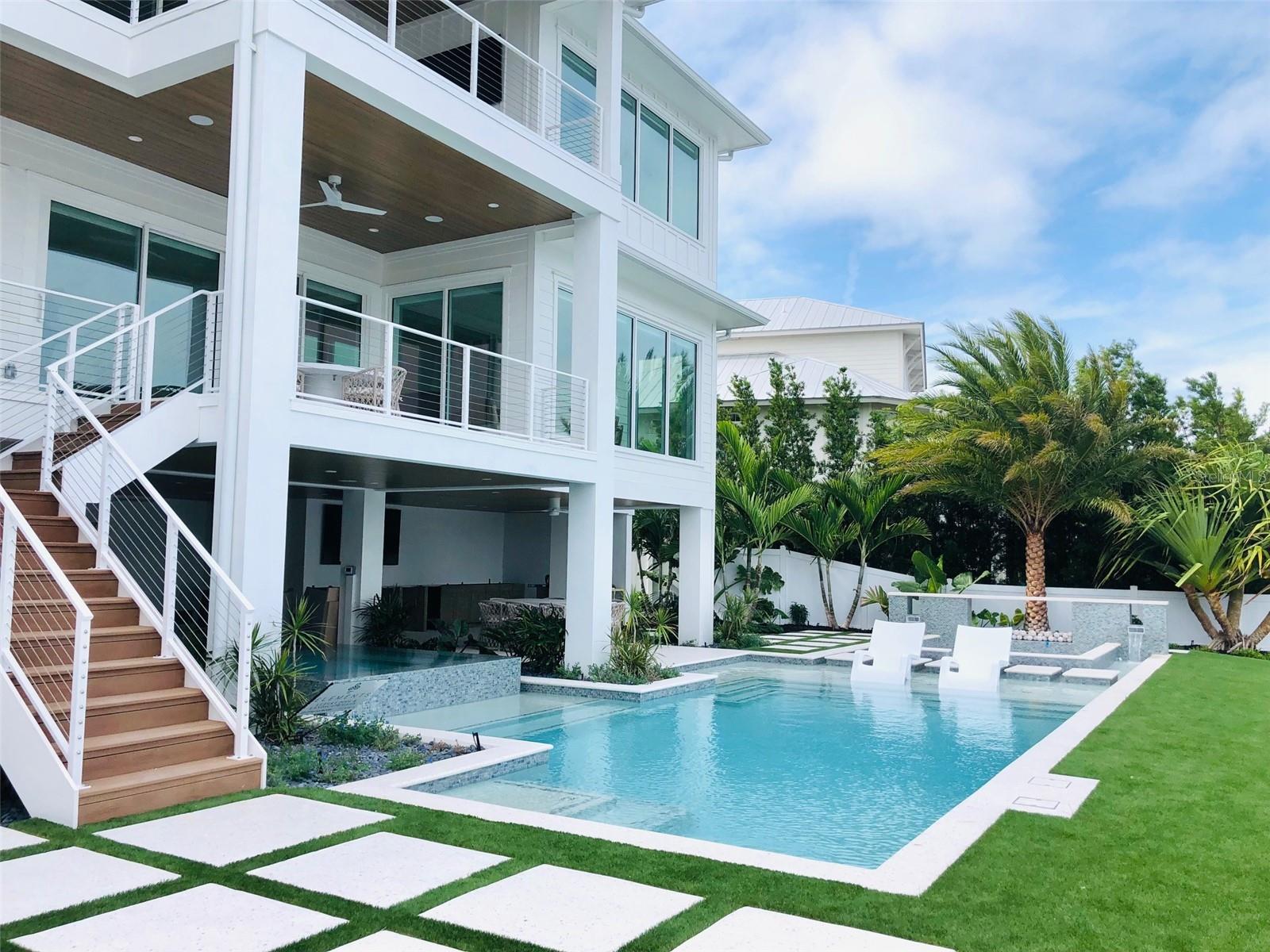 Just completed brand new construction located on the beautiful North end of Anna Maria Island! This Bimini Bay front estate is a boater's dream! An incredibly well appointed, expansive home sitting on 90' of deep protected sailboat water. This stunning home features 4 bedroom, 4 baths, office, large covered decks and 2 powder rooms. Open floor plan, hand scraped white oak floors, Gourmet chef's kitchen with subzero and wolf appliances, large kitchen island designed for entertaining. Master suite and owners' study on the main level. Control 4 panels with built in speakers throughout interior and exterior. Every room in this custom-built home features gorgeous views of Bimini Bay and Galati Marina. Outdoor kitchen with two Wolf grills, tropical pool and spa all overlook the Bay and mature landscaping. This home is offered completely fully furnished and custom Lutron blinds. 5-minute boat ride to open waters of Tampa Bay and Gulf of Mexico. Come experience some of the best beaches and sport fishing in Florida. Walking distance to shops, beaches and restaurants. Come see this amazing new built home today!!