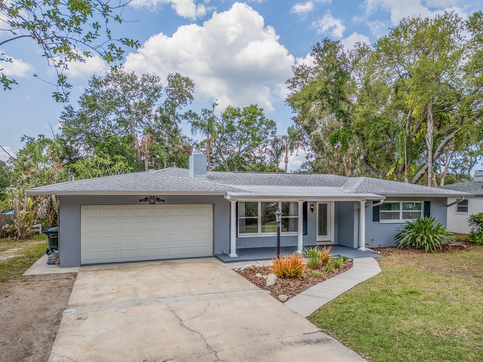 Spacious and open pool home with serene view of spring fed lake. X500 zone typically No Flood Insurance required. 3 bedrooms, 2 baths and a 2 car garage with over 1,400 square feet of living space. Beautifully pavered pool deck with covered area and gorgeous views of the trees and lake. Split floor plan, inside laundry room with sink next to garage entry. Well maintained home in a great location - just one block from Eagle Scout Park, which includes a community garden, pickleball courts, picnic pavillion and a walking/jogging path, and approximately 1 mile from Achieva Paw Park. Less than one mile to downtown Delightful Dunedin, and just minutes to the beaches!