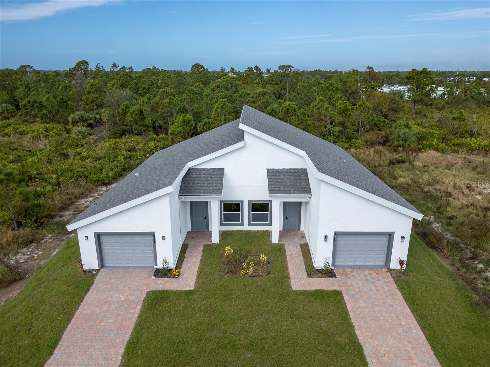 This modern new construction duplex offers two 3/2 units, each with about 1,200 sq ft, a private driveway, and a one car garage. With contemporary finishes, cathedral ceilings, and an open floor plan, this property is perfect for investors or multi-generational living. Both units feature white shaker style cabinetry, stainless steel appliances, impact windows, quartz countertops, and vinyl plank flooring throughout. Enjoy low-maintenance living and energy-efficient features. Don’t miss out on this excellent opportunity being offered at an amazing price!