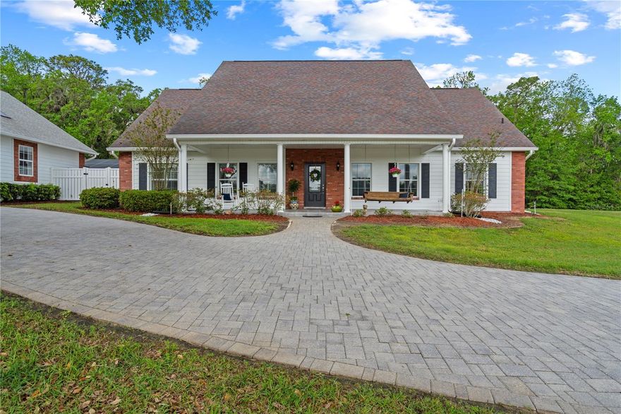 Welcome to this one of a kind, spacious country estate with old Florida charm.  As you enter the property through an electronic entrance gate, you will pass by the large stock pond and gradually make your way through the private, wooded drive, which borders over 300 acres of protected Hernando County wildlife and preserved land with numerous hiking trails and natural amenities, all within minutes from this sprawling property.
Entering this impeccably maintained 3 bedroom, 2 ½ bath home, there are dramatic cathedral ceilings in Entry, Dining & Living rooms with a large flagstone fireplace and hearth.  The eat in kitchen is a chef’s dream, with floor-to-ceiling custom cabinetry,  bay windows and granite countertops.  A spacious center island gives you additional work and eating space, with second sink and a window seat overlooking the front pasture. The oversized Primary bedroom has two large, custom walk-in closets, a walk-out, screened patio with access to the outside and attached is a natural-stone tiled bathroom with a walk-in shower, granite countertops and double sinks with separate vanities. 
There is also a dedicated home office, a large family room with skylights and a separate laundry room with washer/dryer, mud sink and natural-stone tiled floor. Other upgrades include ceiling fans in all rooms and on the porch and Bimini shutters and custom draperies throughout the home.
In addition to the attached 2-car garage, other outstanding amenities include a screened porch (1540 sq. ft.), a large barn (1152 sq. ft.) and a newly renovated in-ground pool (640 sq. ft.) with sun-shelf and enclosure. There is also a detached 4-car garage connected to a finished workshop (1925 sq. ft.) - Perfect for avid hobbyists or a future large guest suite. This space includes a ½ bath and a fully-decked, standing-room attic which runs the length of the structure. High & dry location, zoned for agriculture, this all could be your perfect retreat, working farm or just about anything you could imagine!.  Hurry and make an appointment to see this beautiful  property before it's gone!