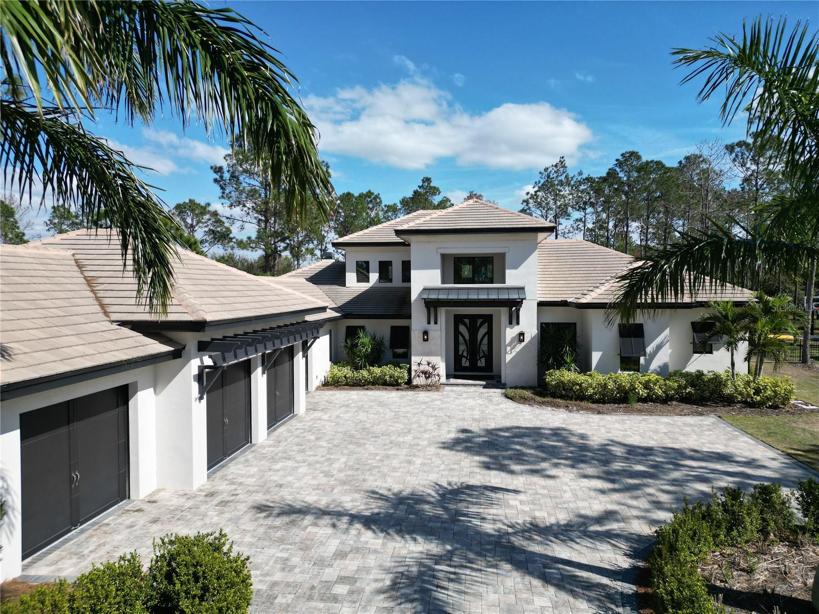One or more photo(s) has been virtually staged. Welcome to Villa del Mar – a breathtaking custom masterpiece by J. Drewes, nestled in the heart of Bella Collina, Central Florida’s most exclusive luxury community. Spanning 1.28 acres of pristine preserve land, this estate seamlessly blends elegance with nature, offering an unparalleled indoor-outdoor living experience.
Step through the grand custom double doors and into a world of sophistication. The soaring 23-foot atrium great roomstuns with tongue-and-groove ceilings, rich wood beams, engineered hardwood floors, and a striking brick fireplace—a space designed to impress and invite.
Culinary enthusiasts will delight in the gourmet chef’s kitchen, where 3-inch Quartz countertops, custom wood cabinetry, and top-of-the-line Sub-Zero & Wolf appliances create the perfect backdrop for both intimate meals and grand entertaining. A large walk-in pantry, dry bar, Wolf espresso machine, and bar fridge elevate every culinary moment.
The primary suite is a sanctuary of tranquility, offering private pool access, a stunning preserve-view picture window, a spa-inspired ensuite with a soaking tub, double vanity, and an expansive walk-in shower. Thoughtfully designed as a 5-bedroom estate with a separate casita, the home is currently configured as 4 bedrooms, an office, and a casita—a space that adapts effortlessly to your lifestyle, whether as a guest retreat, art studio, or personal haven.
Step outside and experience Florida living at its finest. The outdoor oasis boasts a summer kitchen, fireplace, and retractable electric screens, all leading to the resort-style pool and swim spa—a private retreat that invites relaxation and entertainment alike.
Additional luxuries include a 4-car garage, a state-of-the-art smart home system, and a stylishly designed laundry and mudroom.
Living in Bella Collina means access to a world-class Sir Nick Faldo-designed golf course, scenic walking trails, a resort-style pool, a full-service spa, fitness center, fishing, Har-Tru tennis and pickleball courts, and two exclusive clubhouse restaurants. Just minutes from Montverde Academy, the West Orange Trail, charming Downtown Winter Garden, and Clermont’s vibrant lake life, and within an hour of Florida’s stunning beaches—this is more than a home; it’s a lifestyle.
Experience the pinnacle of luxury living. Schedule your private tour today!