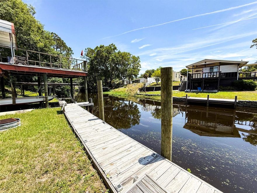 MOTIVATED SELLERS....Waterfront 3BR/2BA home on canal leading to Dunn's Creek, perfect for boating and fishing! Relax on the covered 8x12 back deck with peaceful water views. Home features brand new HVAC with warranty, newer refrigerator, double oven, and stackable washer/dryer, and new front and back doors with storm doors. Underground utilities keep the landscape clean and tidy. The 20x48 metal garage is equipped with a hydraulic car lift and 200-amp service--ideal for storage or workshop. Outdoors, enjoy a boat hoist, new dock pilings, LED lighting along the dock, and exterior security lights for added safety. There is an additional storage/outbuilding with electric, washer/dryer hook up and a sun deck that overlooks the canal. An artisan well provides irrigation for the yard. Whether you're looking for a weekend retreat or full-time residence, this home offers the perfect blend of comfort, and direct water access. Don't miss your chance to own this slice of Florida paradise!