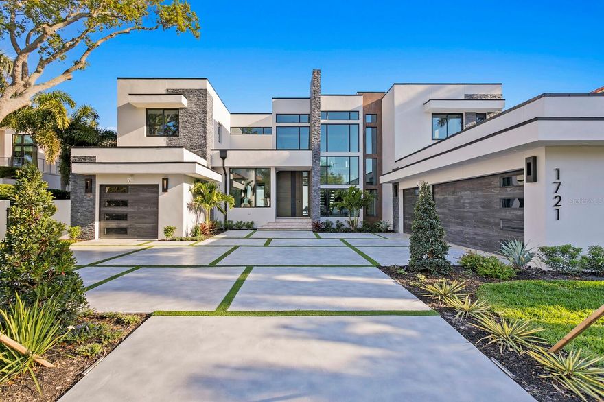 Live the dream in this under construction modern masterpiece boasting state-of-the-art design, exquisite finishes, and 100’ of water frontage with breathtaking open views of Tampa Bay. This spectacular Brightwaters Blvd. gated estate is situated on the coveted street of the exclusive Snell Isle neighborhood in St. Petersburg. Featuring 7,087 sqft. of sweeping open floor plan with 6 bedrooms, 7 full baths, 2 half baths, 4 car garage and built with exterior concrete block construction, impact windows/doors, and elevated living for flood risk reduction and optimal insurance premiums.  Indoor and outdoor living spaces flow seamlessly on one level rarely found in today’s design into exceptional resort-style living, with a covered entertainment area, outdoor kitchen, and infinity-edge pool and spa area with marble pavers overlooking the downtown skyline. The grand entrance exudes style and sophistication with a 5’ x 10’ pivot style door opening to the two-story foyer and leading into the great room with soaring ceilings open to the second floor, a stone floor-to-ceiling fireplace, and widest-open views available. The chef’s kitchen is an entertainer’s delight with custom cabinetry, Wolf and Sub-Zero appliances, a custom walk-in pantry with a hidden door, wine cellar, 2 islands with quartzite countertops open to the Great Room, and the Entertainment Retreat complete with a wet bar. The luxurious Master suite located on the first floor is the perfect sanctuary for relaxation with a spa-like master bath, Cristallo quartzite countertops, and an oversized walk-in closet with custom cabinets. A home office with water views located on the first floor offers convenience and function. A grand floating staircase with glass railings leads to the second level with 5 ensuite bedrooms plus a large glass wall bonus room perfect for a gym, spa room, or media room. The oversized second-floor balconies showcase endless water views of the St. Petersburg skyline, St. Petersburg Pier, and the Sunshine Skyway Bridge. Additional features include an elevator, Generac whole house generator, new dock with a new 15,000lbs boat lift, smart home tech, and specialty lighting. This truly exceptional property is sure to impress those with the most discerning taste and seamlessly blends a pure luxury lifestyle with spectacular water views, boating and downtown St. Petersburg access. Conveniently located near downtown St. Petersburg, the St. Pete Pier, award-winning beaches, the Historic Vinoy Renaissance Hotel and Golf Club, Tampa International Airport, shopping, and fine dining. Exacting standards, exceptional outdoor & entertaining space and unobstructed open water are what make this Brightwaters Blvd. offering considered the CROWN JEWEL of not only Snell Isle, but all of St. Petersburg. Live the luxurious Florida lifestyle!