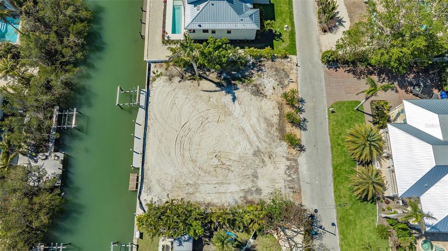 Welcome to the perfect opportunity to build your dream home in the coveted Sleepy Lagoon Park on Longboat Key! This desirable lot is located on a saltwater canal with direct access to the Intracoastal Waterway, Sarasota Bay, and the Gulf of Mexico—perfect for boating enthusiasts. With the current structure on the property being removed in the coming weeks, this lot is ready for you to envision and create your ideal waterfront retreat. Two lots from the mouth of the canal, the property offers peekaboo views of the bay and the potential for even more breathtaking vistas with the right elevation and design. Imagine waking up to serene sunrises, taking morning walks along the nearby beach, and catching stunning sunsets every evening. All utilities are in place, making this lot a seamless canvas for your new construction. Enjoy the quintessential Longboat Key lifestyle with nearby amenities such as fine dining, shopping, tennis, fitness clubs, and community parks. This is your chance to own a prime piece of land in one of the most desirable locations on the island. Call today for more details and to schedule your private tour of this exceptional property. Don't miss this rare opportunity to bring your dream home to life!