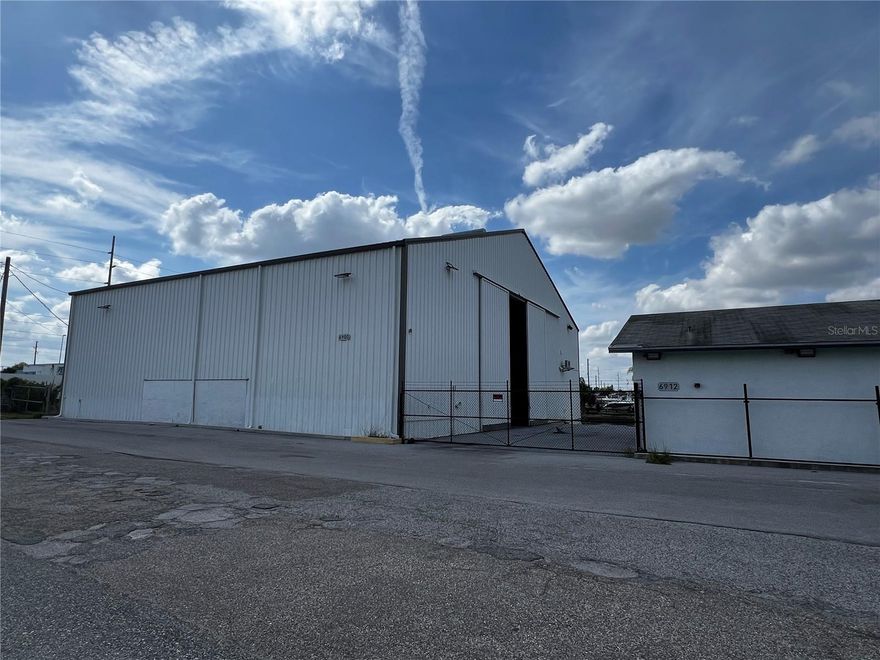 Marina/warehouse building 6750' for boat storage, 2 additional buildings 600' and 1200', all chain link fenced with two rolling gates, boat ramp and dock on the canal. Some water intrusion from Hurricane Helene, but little damage. Zoned C2 and AE flood zone. Just 1 mile to Hudson Beach. Great for boat storage. Possible seller terms. Additional 1.38 acres across the street north is available, fronts us 19, fenced with 36' x 66' pole barn, great for boat, RV, car storage, retail, convenience store $795,000.