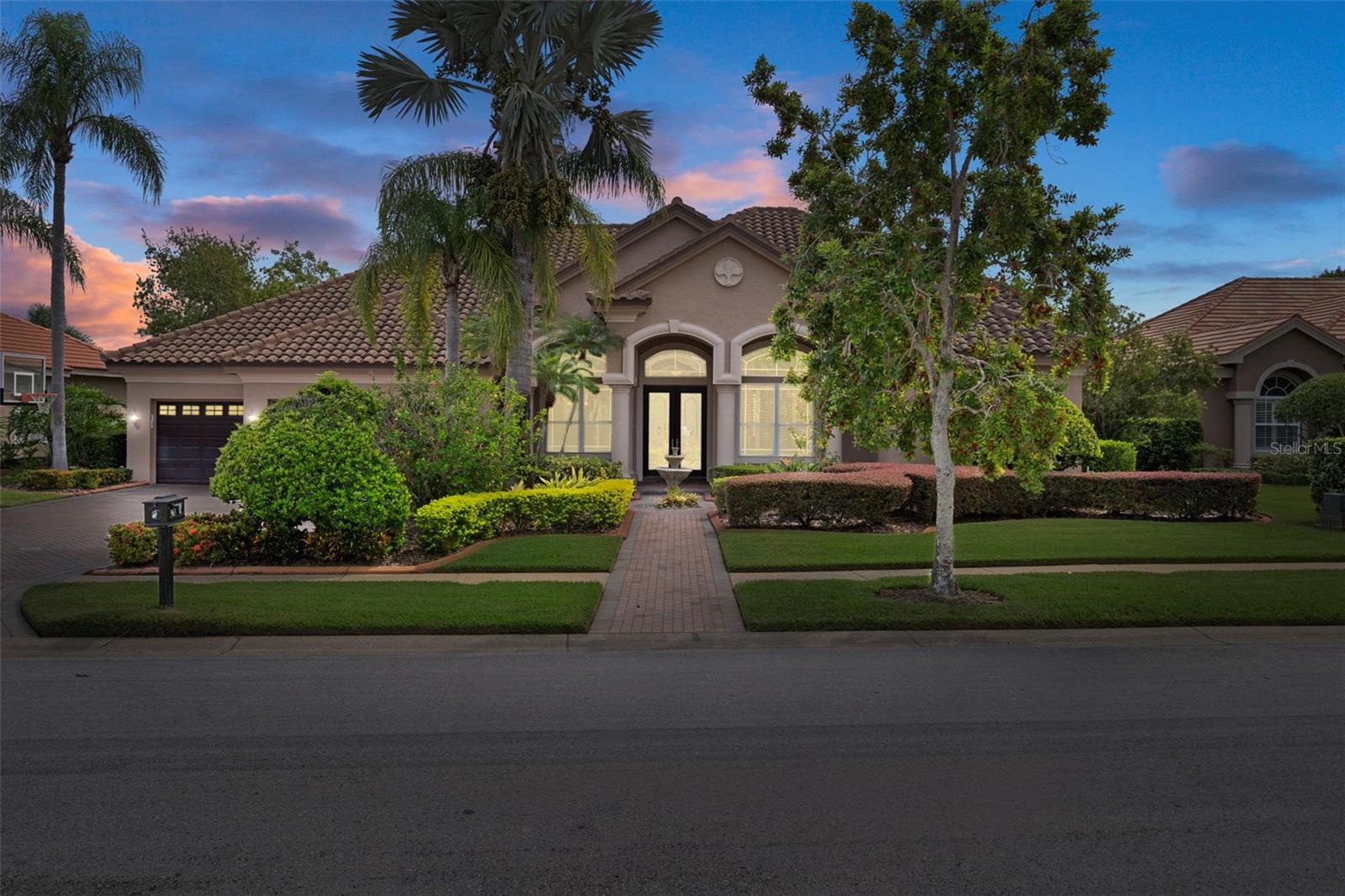 Welcome to Cypress Cove – an exclusive gated enclave of only 28 estate homes, where opportunities to purchase are incredibly rare.
This WATERFRONT 4-bedroom + office + bonus residence offers 3715 sq. ft. of versatile living space designed for both elegant entertaining and everyday comfort. A brick-paver driveway leads to the grand entry, where you’ll find rich wood flooring, formal living and dining rooms, and a wet bar with multiple refrigerators—perfect for hosting gatherings. The home’s thoughtful three-way split plan accommodates large households with ease.
The oversized primary suite features plantation shutters, pool and pond views, and a beautifully updated bath with a walk-in shower, dual vanities, and an expansive custom closet.
The chef’s kitchen boasts ample cabinetry, bar seating, and opens seamlessly to the impressive great room with gas fireplace. Two bedrooms with newer carpet and a full bath are conveniently located off this space, while the private in-law suite includes its own sitting area, bedroom, bath, and backyard access—ideal for multi-generational living or long-term guests. Upstairs, a massive bonus room with a walk-in-closet and full bath offers endless possibilities—game room, home theater, or additional guest space.
Step outside to your tropical oasis: brick paver deck, screened heated pool, spillover spa, updated jets, and a color-changing light display (2020). The fenced yard backs to a serene pond alive with wildlife, creating a truly tranquil setting.
Notable updates include:
Roof (2018)
A/C units (2024, 2014, 2021)
Pool pump (2023), chlorinator (2023), pool/spa heater (2022)
Carpet (2020)
Water softener (2021)
Motorized shades (2020)
Exterior/paver lighting & fountain (2021)
LED recessed lighting with 5 color options (2020)
All this in a prime location—close to dining, shopping, and a quick commute to Tampa, with East Lake High School within walking distance.
Don’t miss this rare opportunity to own in Cypress Cove!