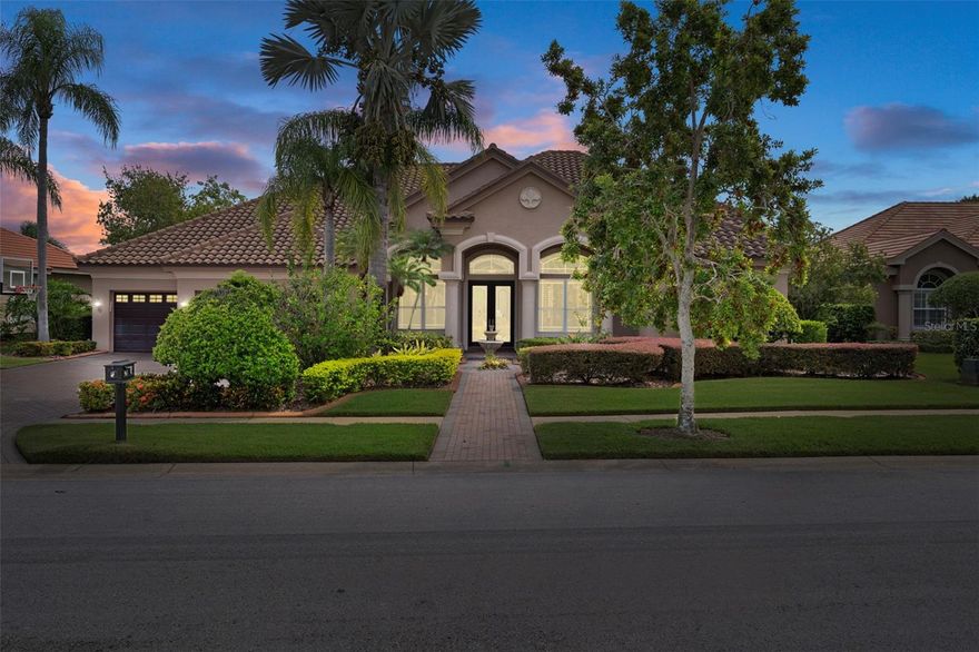 Welcome to Cypress Cove – an exclusive gated enclave of only 28 estate homes, where opportunities to purchase are incredibly rare.

This WATERFRONT 4-bedroom + office + bonus residence offers 3715 sq. ft. of versatile living space designed for both elegant entertaining and everyday comfort. A brick-paver driveway leads to the grand entry, where you’ll find rich wood flooring, formal living and dining rooms, and a wet bar with multiple refrigerators—perfect for hosting gatherings. The home’s thoughtful three-way split plan accommodates large households with ease.

The oversized primary suite features plantation shutters, pool and pond views, and a beautifully updated bath with a walk-in shower, dual vanities, and an expansive custom closet.

The chef’s kitchen boasts ample cabinetry, bar seating, and opens seamlessly to the impressive great room with gas fireplace. Two bedrooms with newer carpet and a full bath are conveniently located off this space, while the private in-law suite includes its own sitting area, bedroom, bath, and backyard access—ideal for multi-generational living or long-term guests. Upstairs, a massive bonus room with a walk-in-closet and full bath offers endless possibilities—game room, home theater, or additional guest space.

Step outside to your tropical oasis: brick paver deck, screened heated pool, spillover spa, updated jets, and a color-changing light display (2020). The fenced yard backs to a serene pond alive with wildlife, creating a truly tranquil setting.

Notable updates include:
Roof (2018)
A/C units (2024, 2014, 2021)
Pool pump (2023), chlorinator (2023), pool/spa heater (2022)
Carpet (2020)
Water softener (2021)
Motorized shades (2020)
Exterior/paver lighting & fountain (2021)
LED recessed lighting with 5 color options (2020)

All this in a prime location—close to dining, shopping, and a quick commute to Tampa, with East Lake High School within walking distance.

Don’t miss this rare opportunity to own in Cypress Cove!