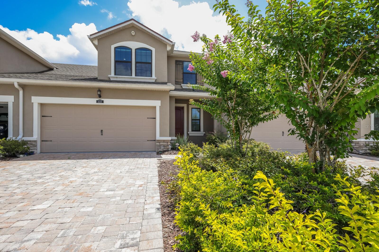 Situated on an intimate street in Harmony at Lakewood Ranch, this stunning lakefront townhome has practically every upgrade available and then some. Built in 2018, the open 1,932 square foot plan features a light and bright great room plan adorned with wood floors & high ceilings plus an open loft area upstairs with unique extra bonus room area ideal for an office or just excess living space. The split 3-bedroom and 2.5 bath Sandbar model offers a main level owner's suite with wood floors, tray ceiling, extra recessed lighting, customized walk-in closet, and glass sliders to the screened lanai. The owner's bath features frameless glass shower enclosure, accent shower tile flooring, dual sink vanity, separate water closet and an oversized tub. Up the gorgeous wood stairway leads to the additional two guest bedrooms just off the second full bath, loft with speakers, and bonus room area. The gourmet kitchen below is open to the dining area and features a large island with quartz counters, white cabinetry, abundance of drawers, pull-out trash receptacle, walk-in pantry, built-in microwave and wall oven, separate cooktop and stainless steel appliances. A main level powder room, central vacuum, water filter system, a laundry room with storage cabinets, and a 2 car garage further sweeten this gem of a property. The community of Harmony at Lakewood Ranch has much to offer its residents with maintenance already included as part of the HOA fee, plus a resort-styled pool, fitness facility, clubhouse, playground, and access to the picturesque Lakewood Ranch trails.