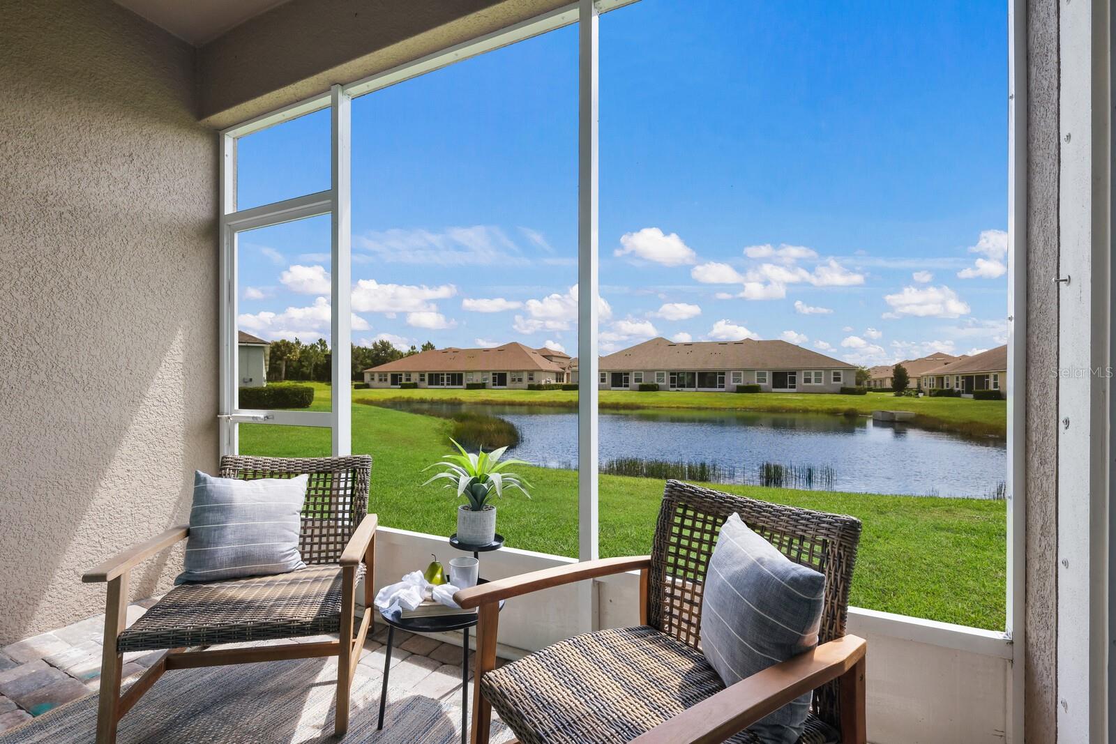 Situated on an intimate street in Harmony at Lakewood Ranch, this stunning lakefront townhome has practically every upgrade available and then some. Built in 2018, the open 1,932 square foot plan features a light and bright great room plan adorned with wood floors & high ceilings plus an open loft area upstairs with unique extra bonus room area ideal for an office or just excess living space. The split 3-bedroom and 2.5 bath Sandbar model offers a main level owner's suite with wood floors, tray ceiling, extra recessed lighting, customized walk-in closet, and glass sliders to the screened lanai. The owner's bath features frameless glass shower enclosure, accent shower tile flooring, dual sink vanity, separate water closet and an oversized tub. Up the gorgeous wood stairway leads to the additional two guest bedrooms just off the second full bath, loft with speakers, and bonus room area. The gourmet kitchen below is open to the dining area and features a large island with quartz counters, white cabinetry, abundance of drawers, pull-out trash receptacle, walk-in pantry, built-in microwave and wall oven, separate cooktop and stainless steel appliances. A main level powder room, central vacuum, water filter system, a laundry room with storage cabinets, and a 2 car garage further sweeten this gem of a property. The community of Harmony at Lakewood Ranch has much to offer its residents with maintenance already included as part of the HOA fee, plus a resort-styled pool, fitness facility, clubhouse, playground, and access to the picturesque Lakewood Ranch trails.