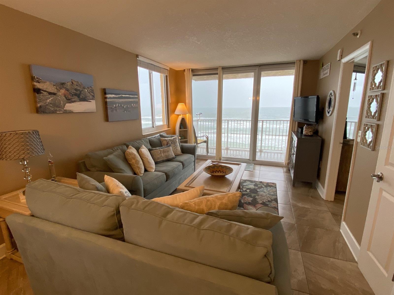 DIRECT OCEANFRONT PANORAMIC VIEWS WALK TO FLAGLER AVENUE DOWNTOWN Available NOW SUMMER RATES from 3 nights, weekly, monthly - Penthouse Paradise! Magnificent "Million-dollar" panoramic OCEAN views! Top Floor, two bedrooms, two full bath corner unit in a Direct Oceanfront in a Resort setting. Gorgeous north view to the Ponce de Leon Inlet Lighthouse and south view to Kennedy Space Center launches. Newly decorated & newly furnished. Unit is fully equipped, including beach chairs, umbrella and towels. All you need for your vacation...just bring a suitcase and toothbrush!  Enjoy breakfast or lunch at the oceanfront bar & grill restaurant right next door. Just a two-block walk to Flagler Avenue, which is the heart of activity on the beachside, with many gourmet restaurants, specialty shops, festivals and parades. Enjoy a Wine Walk every 4th Saturday!  Also, just two blocks to a public park with tennis courts and a basketball court. Amenities include two new elevators, beach with lifeguards, heated swimming pool, game room with pool table, large TV viewing room, business center and on-site parking for one vehicle.  Less than 30-minute drive to Daytona Beach attractions and less than 90 minutes to family attractions in Orlando, St. Augustine and Cape Canaveral, Non-Smoking, no pets. Request for Multiple Months long term rates. Additional fees: vehicle $10.00 nightly resort fee, Damage Insurance $99., Security Deposit refundable nothing missing or broken $1000 for monthly longer stays. Weekly Exit housekeeping fee: $250. On Stays of 6 months or less: additional cost is county & state tax of 12.5.
