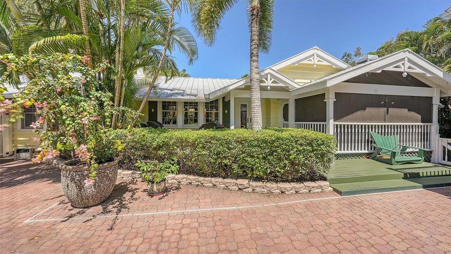 An Oasis in the City. Built in 1941 it was a little Florida "working class shack"(as quoted from Sarasota Herald Tribune) which has been impeccably remodeled to honor the authenticity of the original structure as much as possible. The home is a total fusion of old and new. The exterior is pecky cypress and topped with a metal roof. Beautiful pine floors. Nestled behind the gates is a private courtyard on one of the best streets "west of the trail". It is conveniently located in the much sought after area close to world renowned beaches of Siesta, Southside Village, restaurants, Sarasota Hospital, shopping and in the school district of Southside Elementary. The house boasts a total of 4 bedrooms, 4.5 baths, open kitchen, dining room, living room w/gas fireplace and family room w/wood burning fireplace. There is also a separate guest house . The home is built for entertaining with open floor plan and a fabulous courtyard featuring pool.  Surrounded by dense foliage it is hard to believe it is so close to everything. Located between Osprey and 41. Sitting in this quiet beautiful courtyard you would think you are in Key West.