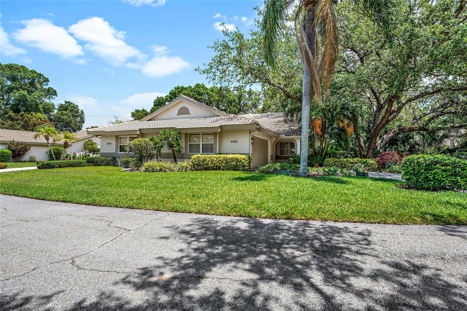 Awesome villa in a beautiful, treed, private community with only 100 homes is now available in Tivoli Village. This well maintained 2bed/2bath plus den/office villa with 2 car garage sits in a lush green setting yet has close access to UTC, I 75, Benderson Park, SRQ, and still only 18 min drive to downtown Sarasota. Enjoy the open kitchen, dining, living room with cathedral ceiling and lots of sunlight. The kitchen includes newer stainless appliances, slide-out shelving in most cabinets and small dinette area. The six foot kitchen counter separates it from the dining area which flows into the large, comfortable living space with sliders out to the enclosed lanai. Pavers extend beyond the lanai to a charming, outdoor tropical oasis featuring native Florida plants and a lovely tiled cement table and benches. The spacious master suite sits at the back of the villa with an updated master bath with dual sinks, granite countertops and a walk-in shower with bench. The split bedroom plan offers you and your guests privacy with the bedroom and bath at the front of the home. The spacious den/office has a skylight and closet. The HOA fees seem high, but they cover many expenses that as a personal homeowner would cost you much more. The list of costs covered is attached to this listing. Ask your agent to see it. But here's just a few...property damage insurance, exterior home power washing and painting, total roof replacement!! plus roof repairs when necessary, all front lawn maintenance and irrigation. This home was painted in Feb2023, and had new AC system in Apr2023. Tivoli Village is a beautiful community with 4 spring-fed lakes, fishing, majestic oak trees and a peaceful nature trail. But the best feature of this community is the people who live there...so welcoming, helpful and fun! Come see for yourself!