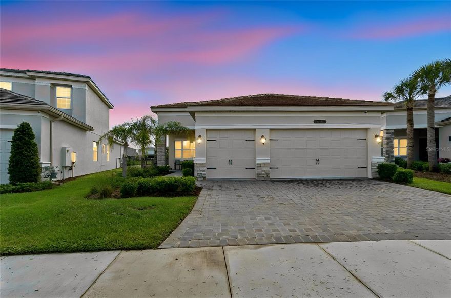 Mediterranean-Inspired Modern Living in the Premier Gated Community of Winding Ridge. 
This stunning single-story home seamlessly blends elegance, comfort, and convenience. It features 3 bedrooms, 3 bathrooms, and a versatile bonus room that can serve as a home office, media room, or guest space. Enjoy this spacious .31-acre lot in a beautifully maintained, gated community that monitors entry and charges no CDD fees, providing privacy and peace of mind. The home combines style and functionality with soaring 10 ft ceilings, custom kitchen cabinetry, a gas stove, stainless steel appliances, granite countertops, and an inviting dining area ideal for entertaining. Retreat to the spacious primary suite with his-and-hers walk-in closets, dual vanity sinks, and a large en-suite bath designed for relaxation and comfort. Benefit from a 3-car garage, a dedicated garage gym, and a well-appointed laundry room with a utility sink. Step outside to your private backyard oasis, where a sparkling saltwater pool, heated jacuzzi spa, and fully equipped outdoor kitchen invite you to entertain. Relax in a fully fenced backyard perimeter and savor peaceful Florida evenings year-round. Residents live the resort-inspired lifestyle, enjoying a beautifully designed clubhouse, resort-style pool, fully equipped fitness center, pickleball and tennis courts, basketball courts, playground, and a vibrant calendar of community events and activities. The HOA delivers true low-maintenance living by handling lawn maintenance, landscaping, irrigation, and trash service. Enjoy a truly prime location—a short drive from Wiregrass Mall, Tampa Premium Outlets, USF, Florida Medical Center, Florida Cancer Specialist, Moffitt Cancer Center, AdventHealth, Pasco-Hernando State College, and AdventHealth Center Ice. Access SR 56, I-75, and I-275 with unmatched convenience.