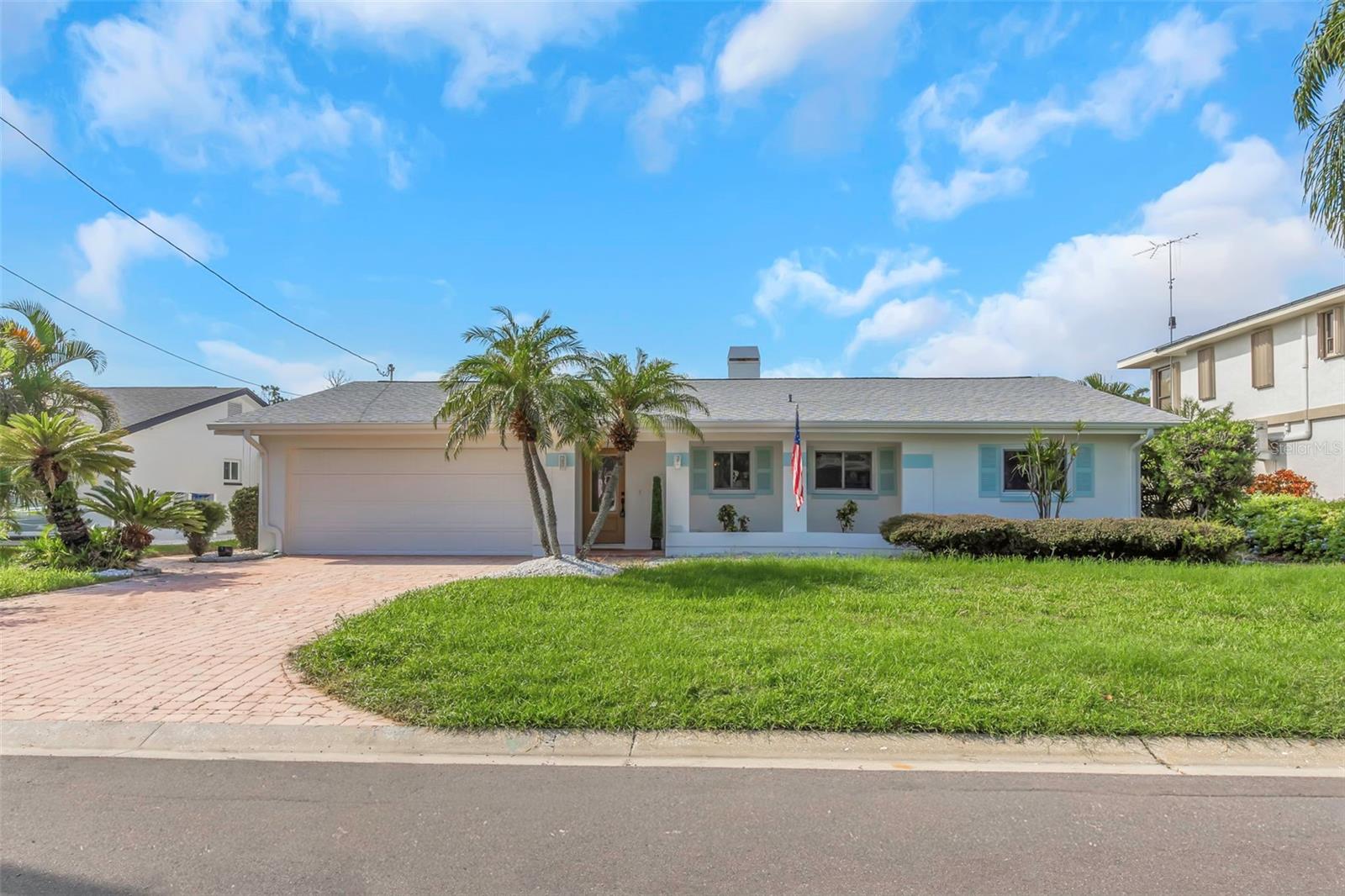 Welcome to 220 Driftwood Dr S, located in the waterfront community of Palm Harbor. This recently renovated 4-bedroom, 2-bathroom home offers an open floorplan with new luxury vinyl plank flooring throughout the main living areas. The updated kitchen features a large center island with a built-in cooktop, providing ample space for cooking and entertaining. A fireplace adds warmth and character to the main living space. Enjoy Florida living with an in-ground pool and spa under a screened enclosure overlooking a canal with direct Gulf access. A private boat dock and lift are included, offering convenient access to the water. The primary bedroom includes a newly renovated en-suite bathroom. Additional features include a 2-car garage and updated interior finishes throughout. All information deemed reliable but not guaranteed. Buyer to verify HOA information, property measurements and waterfront details.