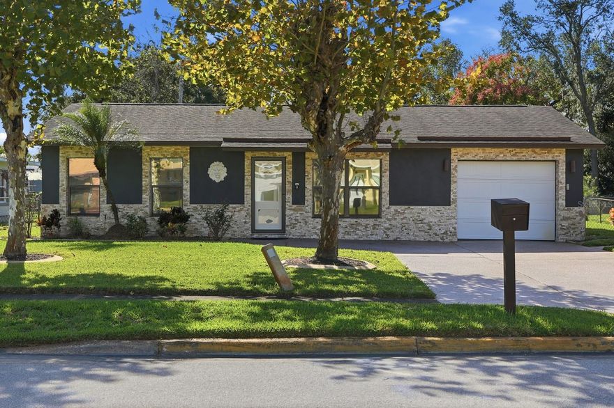 Welcome to this beautifully updated and move-in ready home in a quiet Daytona Beach neighborhood. The home’s modern curb appeal features a stone façade, sleek dark accents, and a stylish front door. Inside, you’ll find a bright open floor plan with luxury vinyl plank flooring throughout and a stunning remodeled kitchen with quartz countertops, stainless steel appliances, and soft-close cabinetry.

This 3-bedroom, 2-bath home includes a spacious primary suite with vaulted ceilings and a private ensuite featuring marble-style tile and a glass-enclosed shower. The large family room opens to a screened-in Florida room overlooking a fenced backyard with plenty of space to entertain, play, or add a pool. A large storage shed, newer roof, fresh paint, updated lighting, and a one-car garage complete the package. Centrally located in Daytona Beach, this home offers quick access to shopping, restaurants, Tanger Outlets, and the area’s beautiful beaches  combining comfort, style, and convenience in one perfect package.